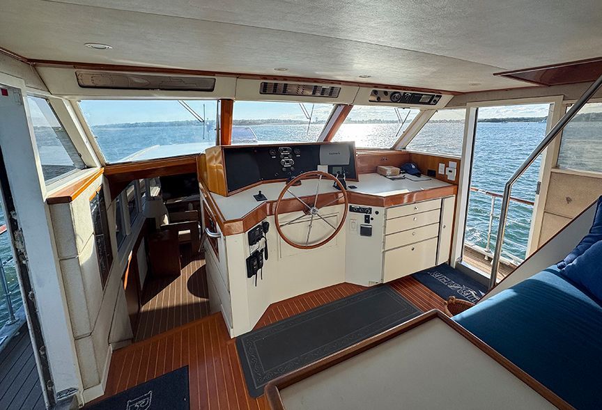 Interior of a 1961 Burger 63 yacht with helm station and ocean view.