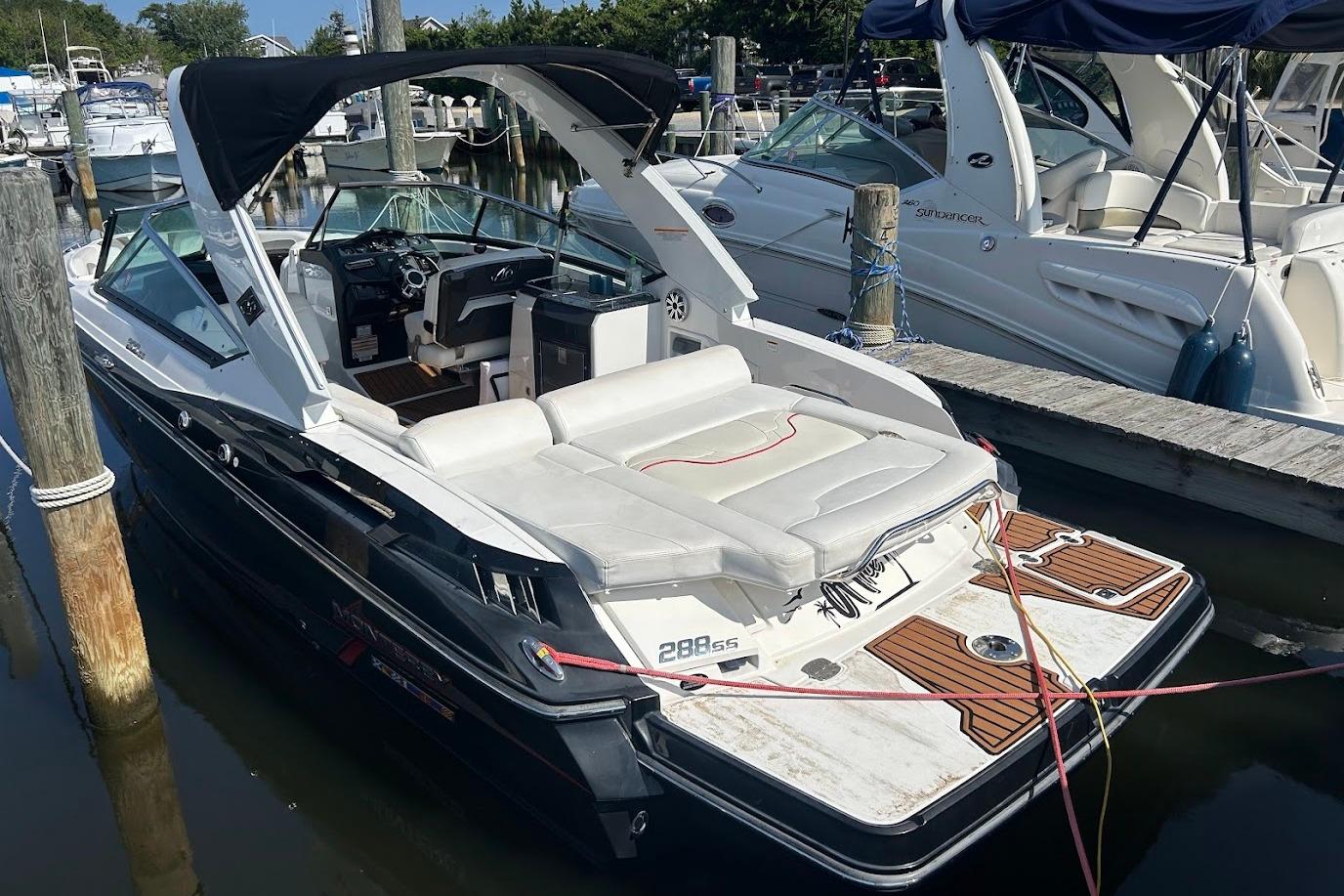 2015 Monterey 288 Super Sport boat docked at marina, featuring sleek design and spacious seating.