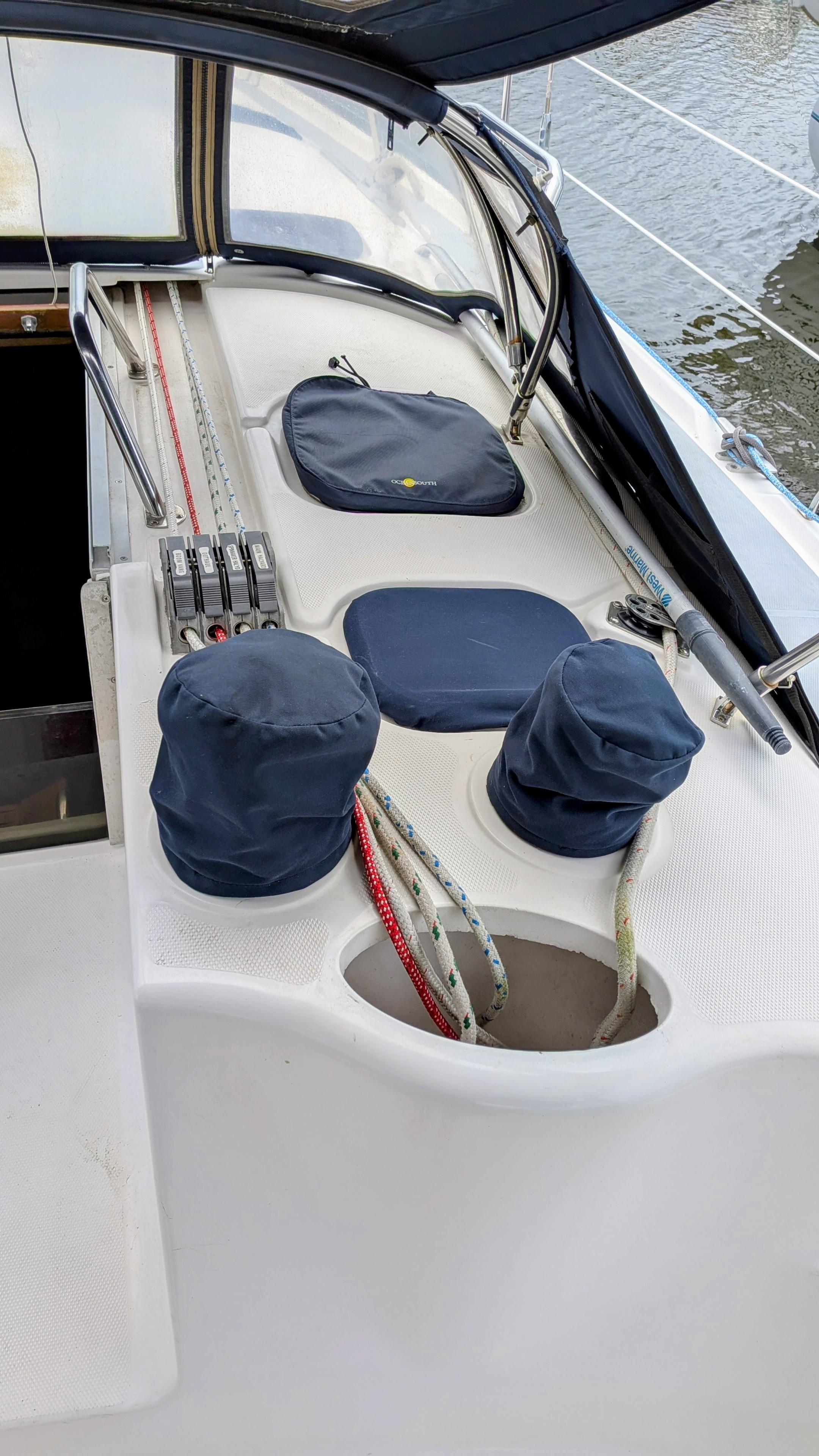 Sailboat deck of 2001 Hunter 380 with covered winches and ropes.