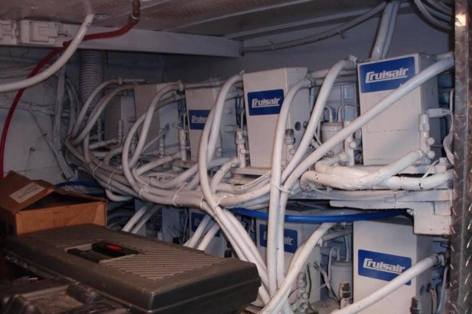 Cruisair units in a 1974 Pacemaker Cockpit Motoryacht engine room, surrounded by cables.