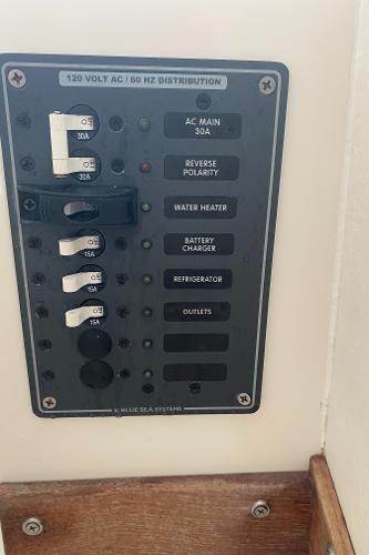 An electrical panel on a boat with various switches and labels.