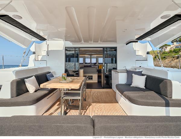Luxurious Lagoon 51 ICONIC 2025 yacht interior with elegant seating and dining area.