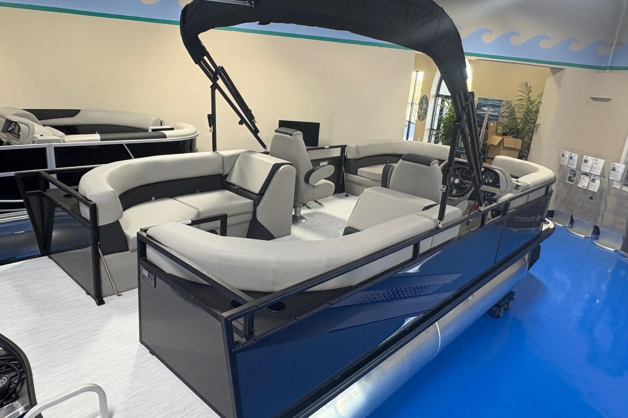2026 Dockside 22DQ pontoon boat with sleek design and spacious seating in showroom.