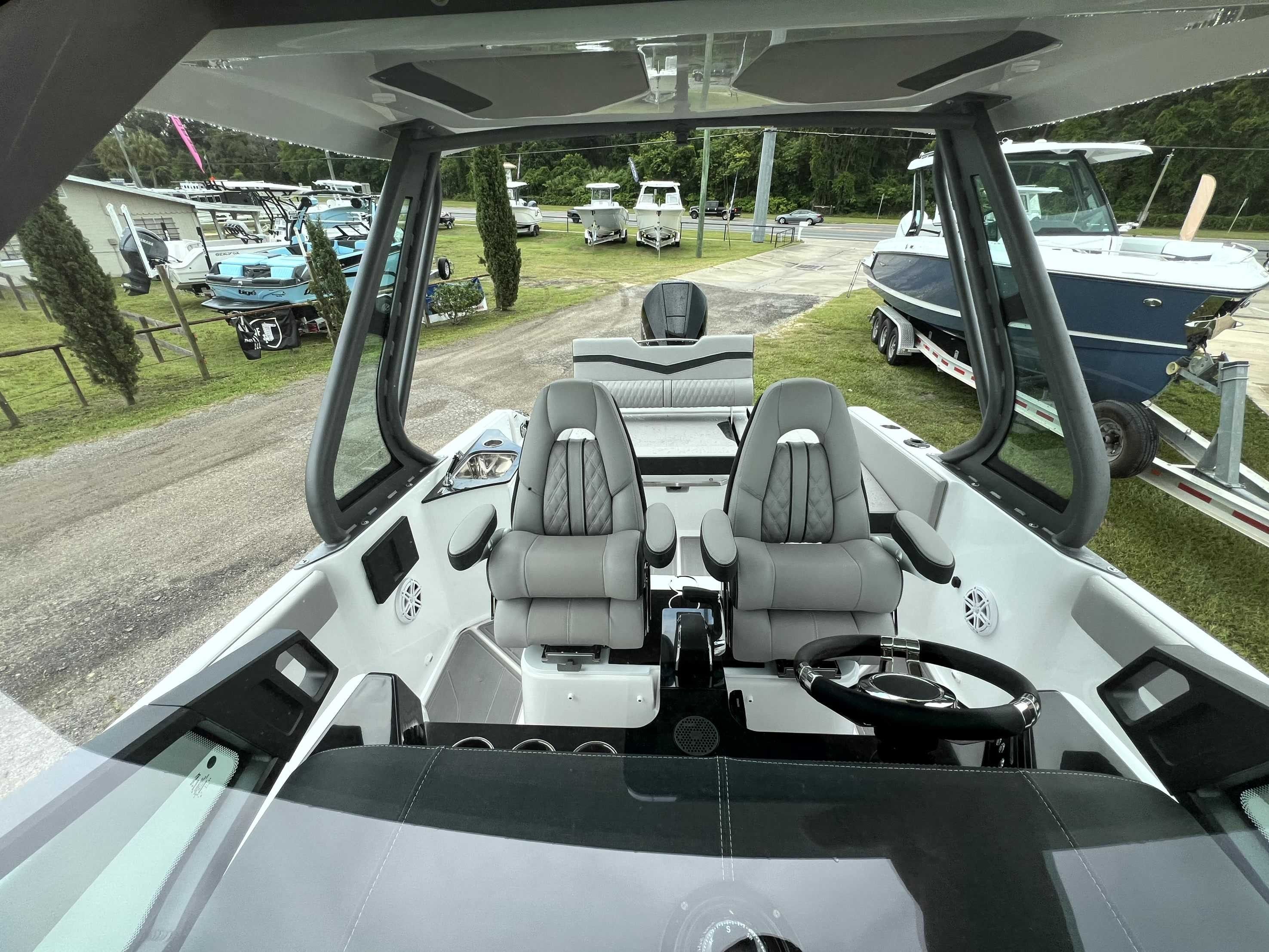 The image shows the cockpit of a Monterey Elite 25 boat with two gray seats.