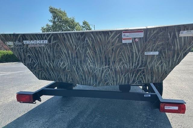 2026 Tracker Grizzly 1648 Utility boat with camo design on a trailer.