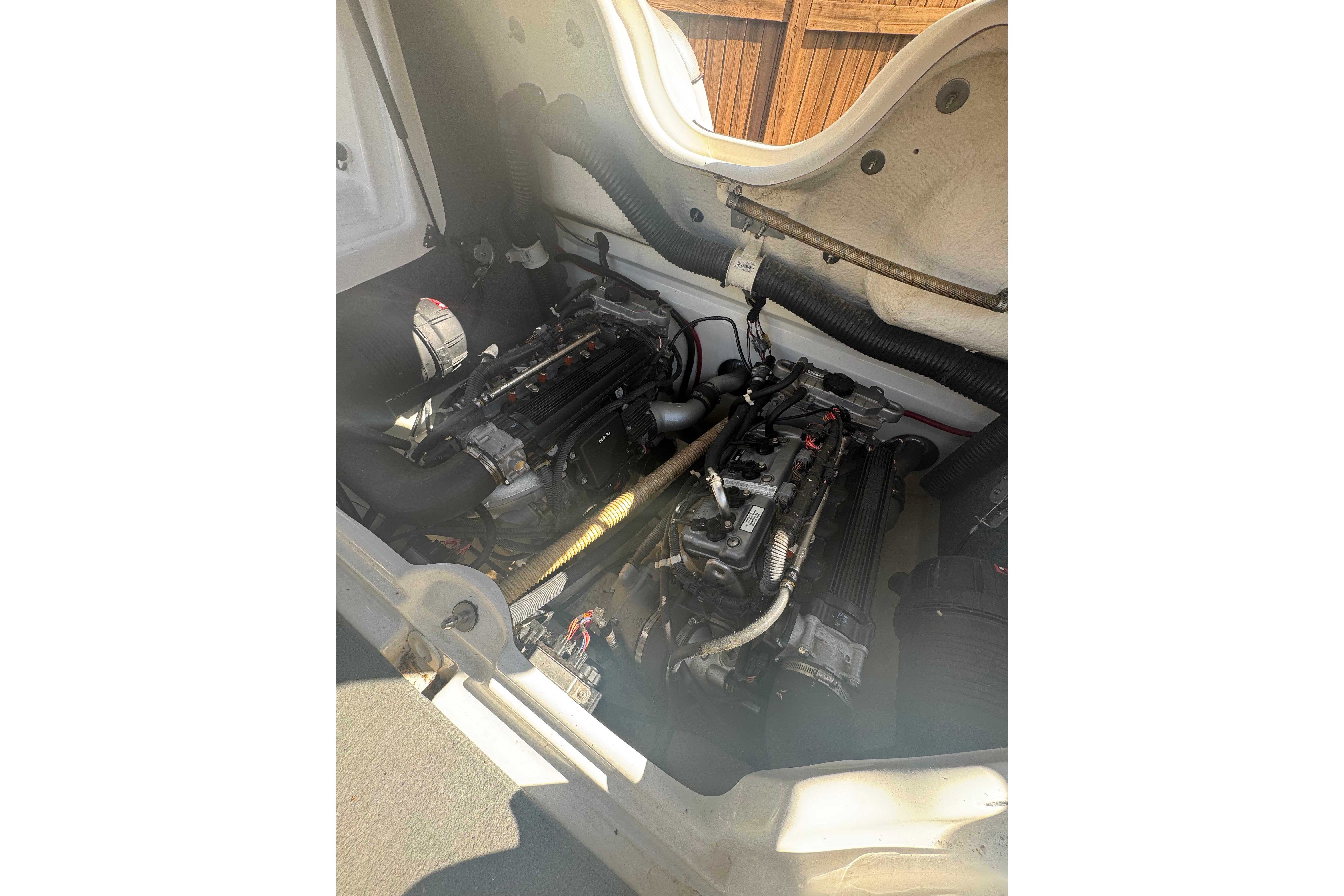 2012 Yamaha AR210 boat engine compartment with dual engines visible.