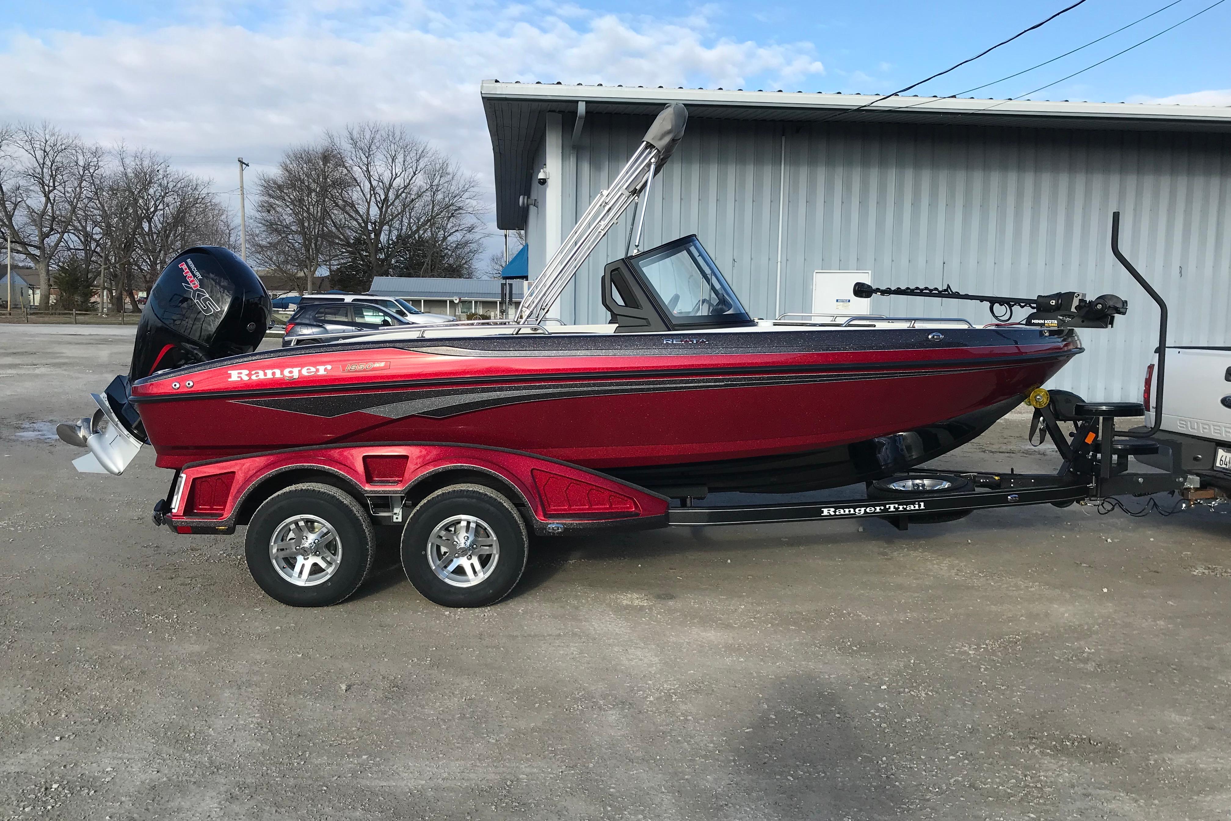 2026 Ranger 1850MS boat in red on a trailer, parked outdoors.