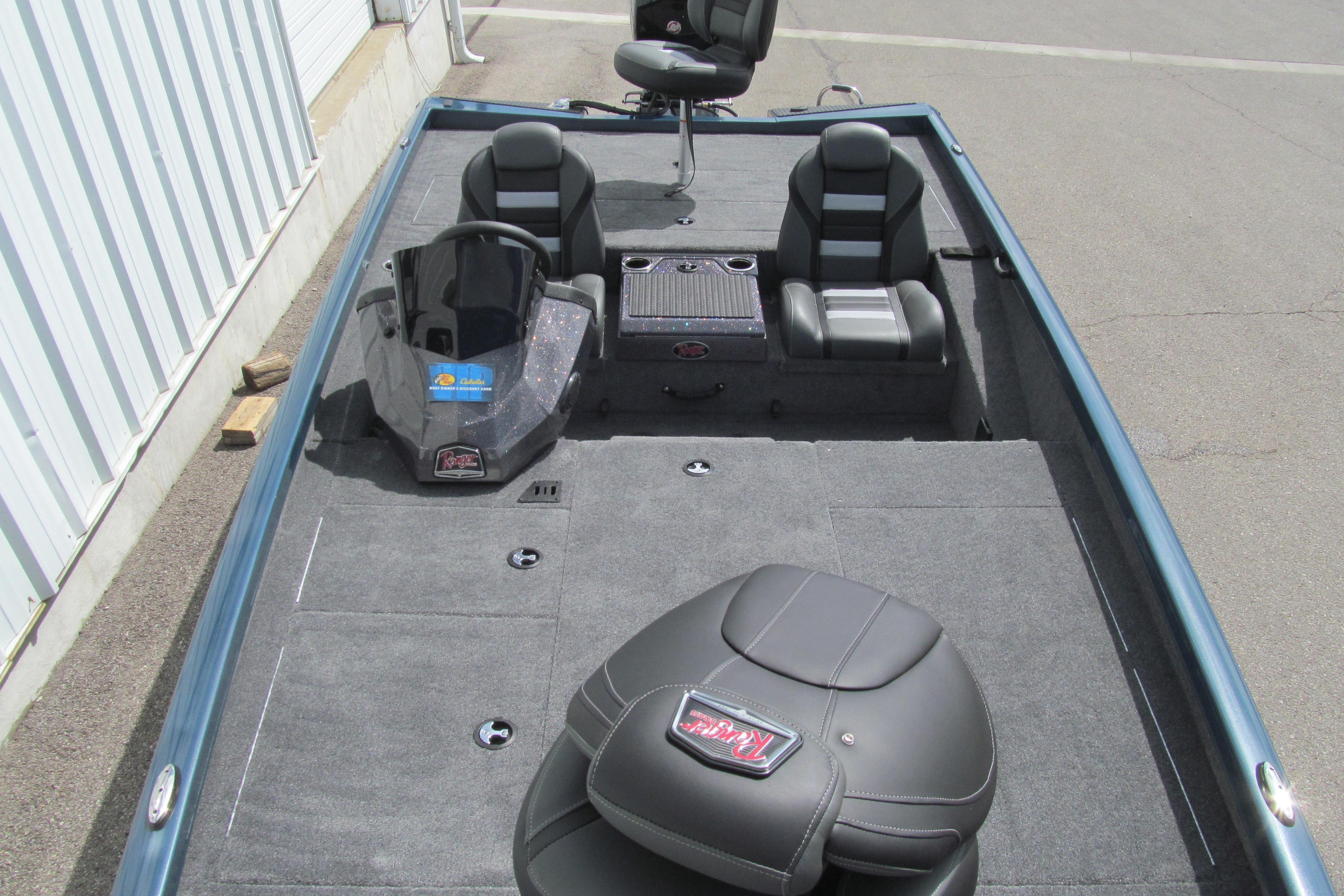 2026 Ranger RT198P boat interior with seating and console, parked on pavement.