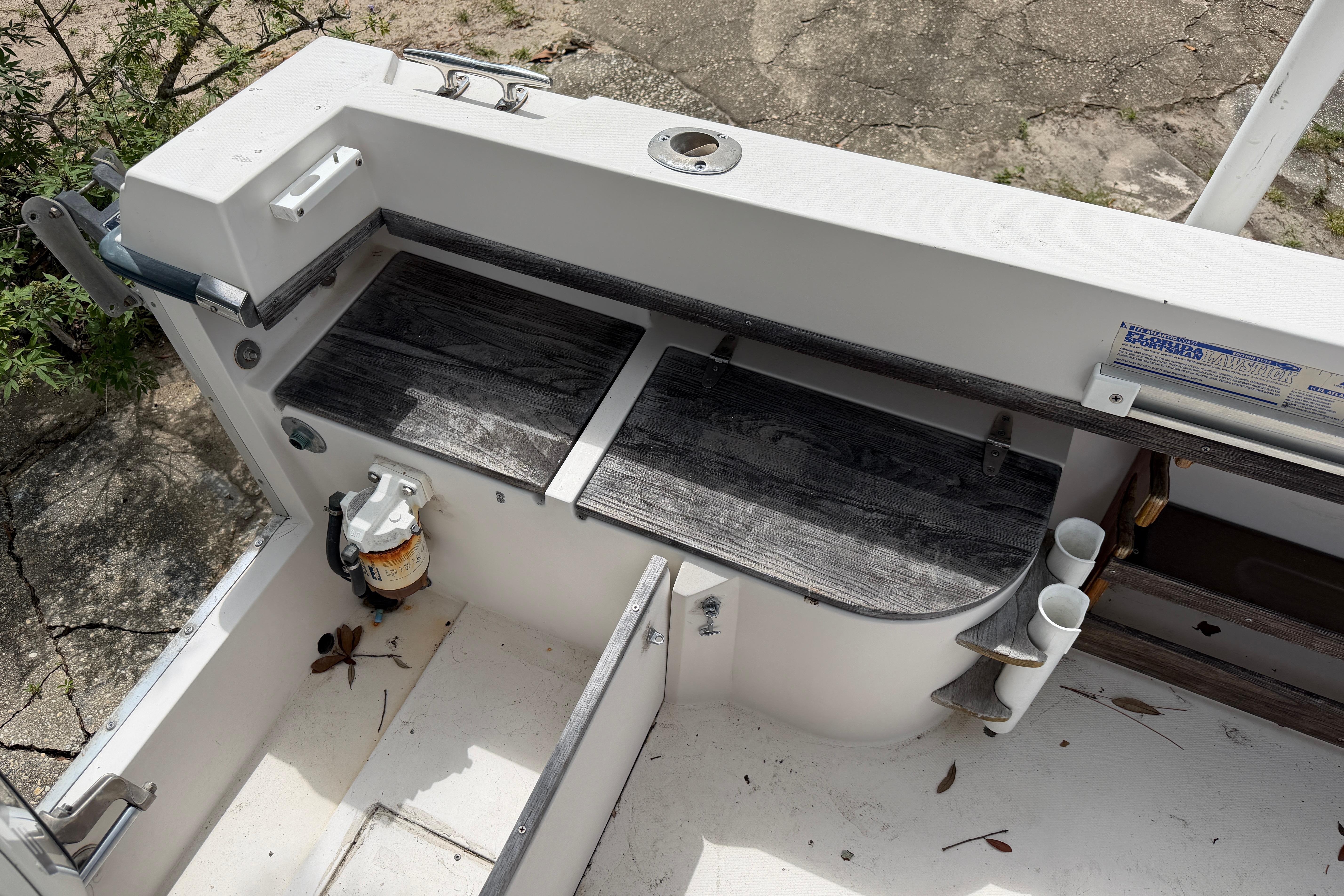 1987 Grady-White Seafarer 226 boat interior with storage compartments and fishing rod holders.