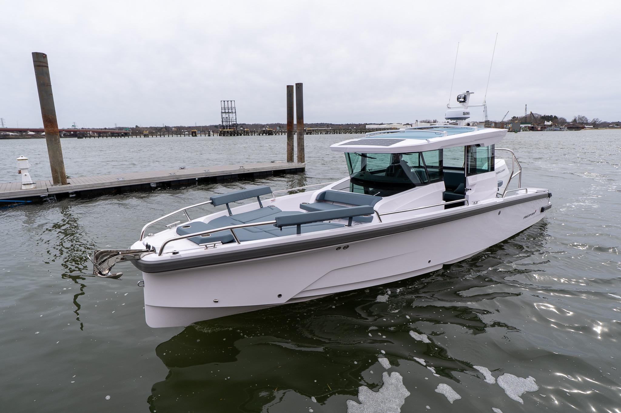 2026 Axopar 29 XC Cross Cabin boat on calm water near a dock.