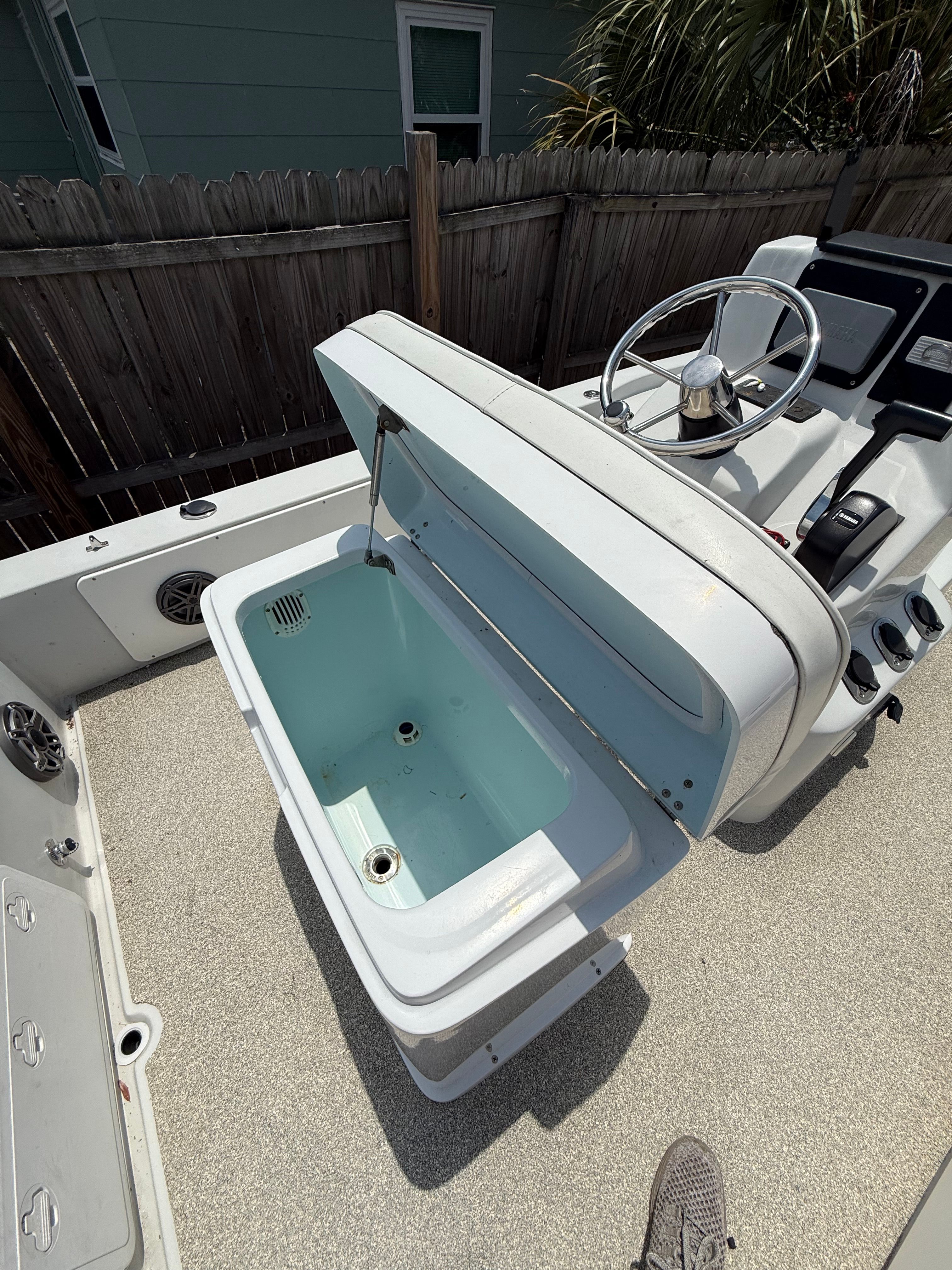 2012 Bay Craft 21 boat with open storage compartment.