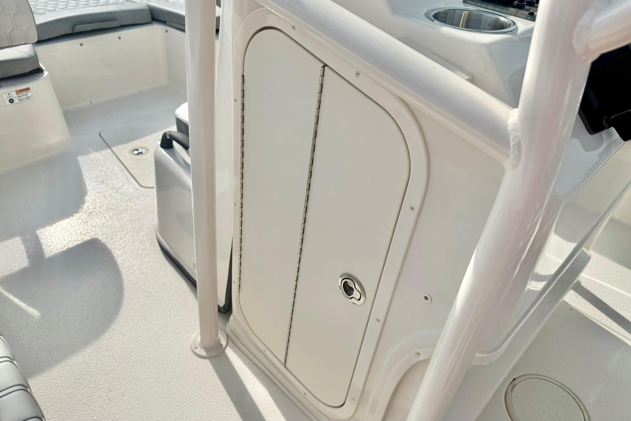 2026 Carolina Skiff 24 Ultra Elite boat interior with storage compartment and seating.