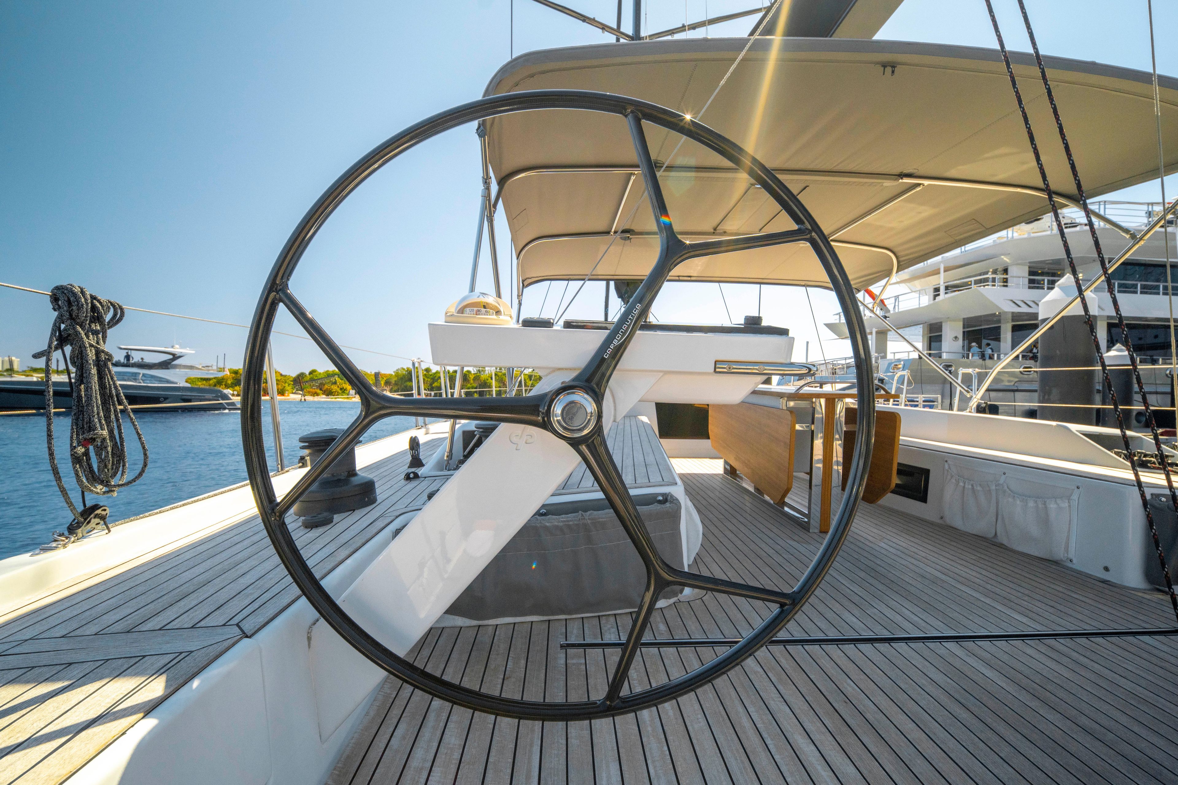 Grand Soleil 58 yacht deck with steering wheel, 2016 model, docked in marina.
