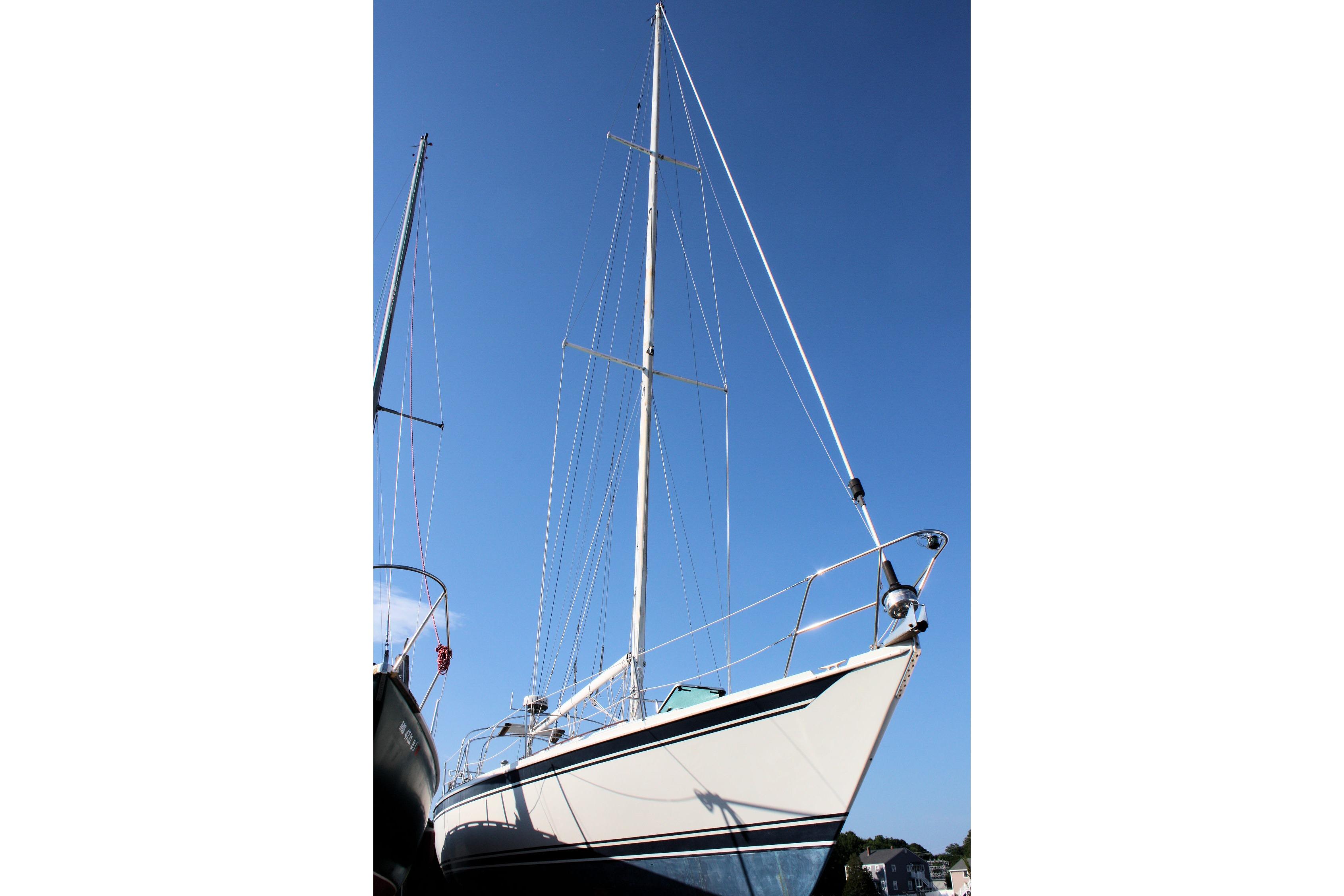 1987 Ericson 38-200 sailboat with tall mast against clear blue sky.