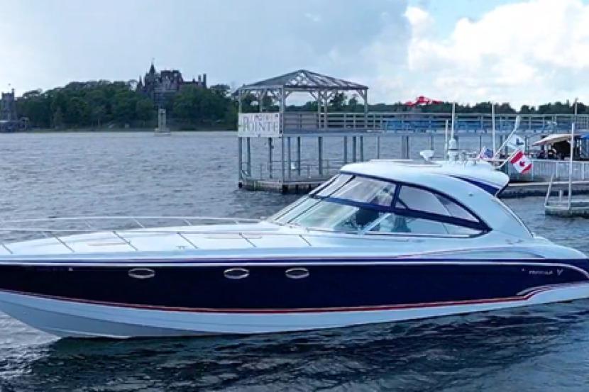 2008 Formula 400 Super Sport boat docked near scenic waterfront.