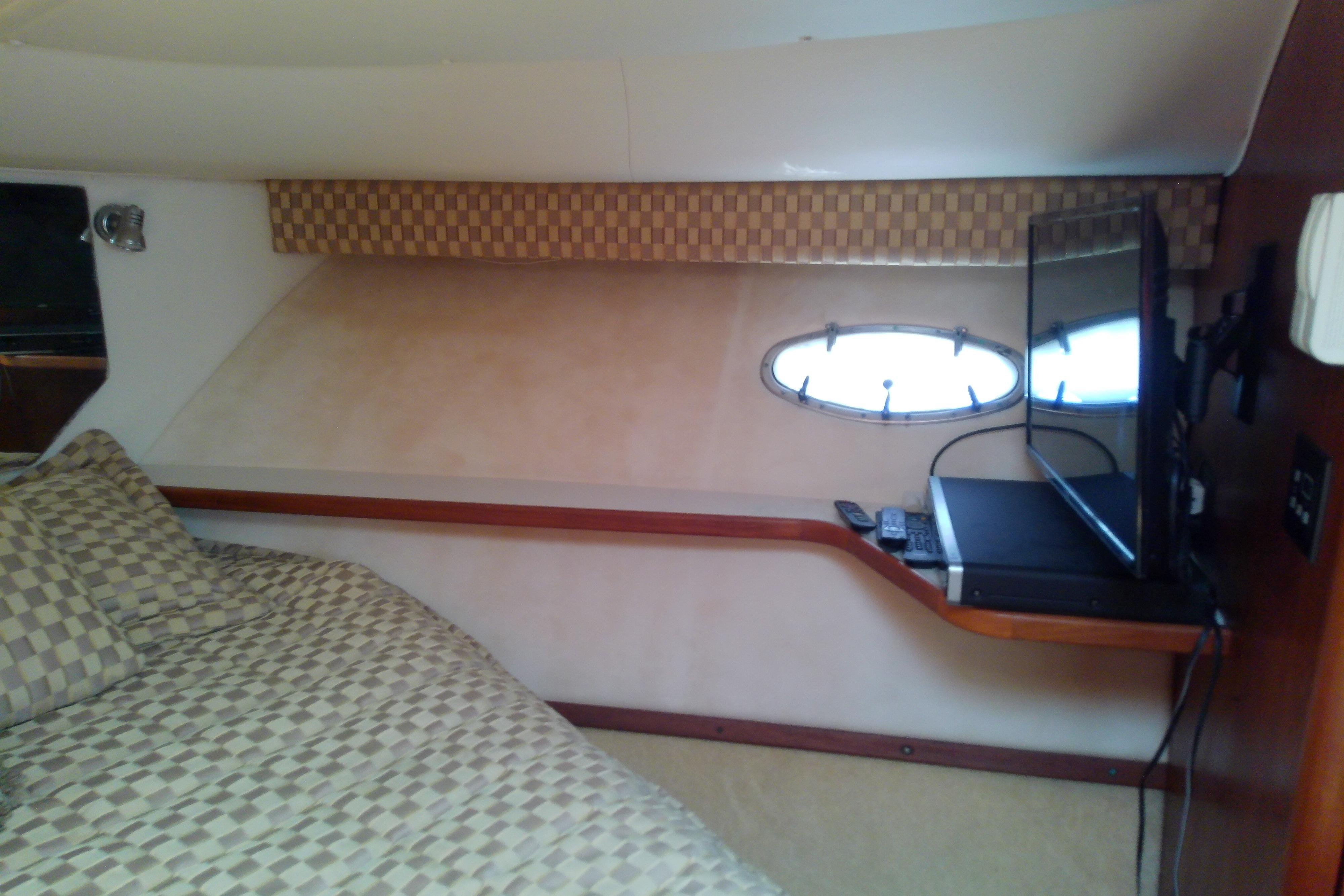 Interior cabin of 2000 Tiara Yachts 4100 Open with bed and TV.