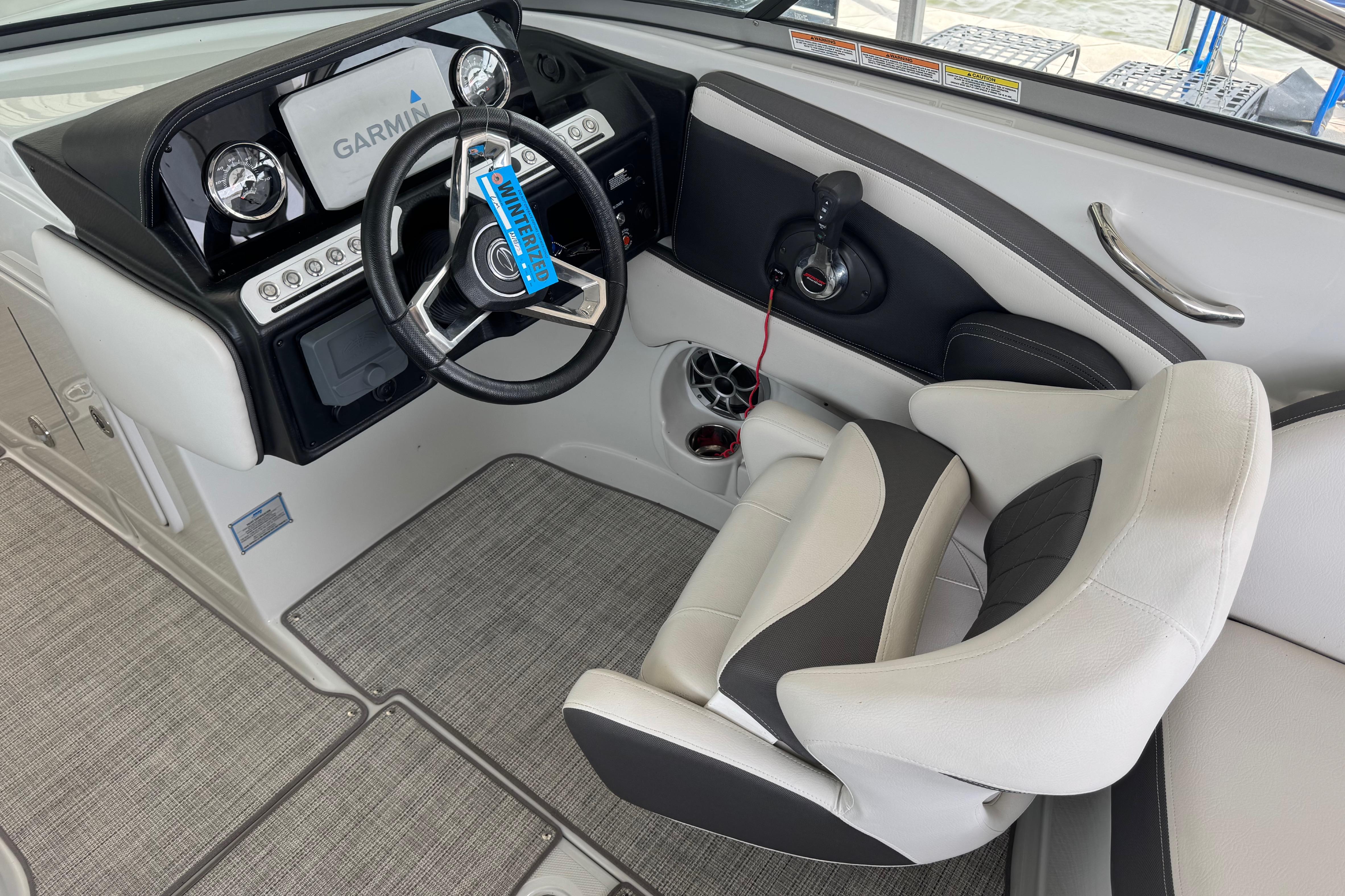 Interior of 2022 Crownline 265 SS boat with Garmin navigation system and plush seating.
