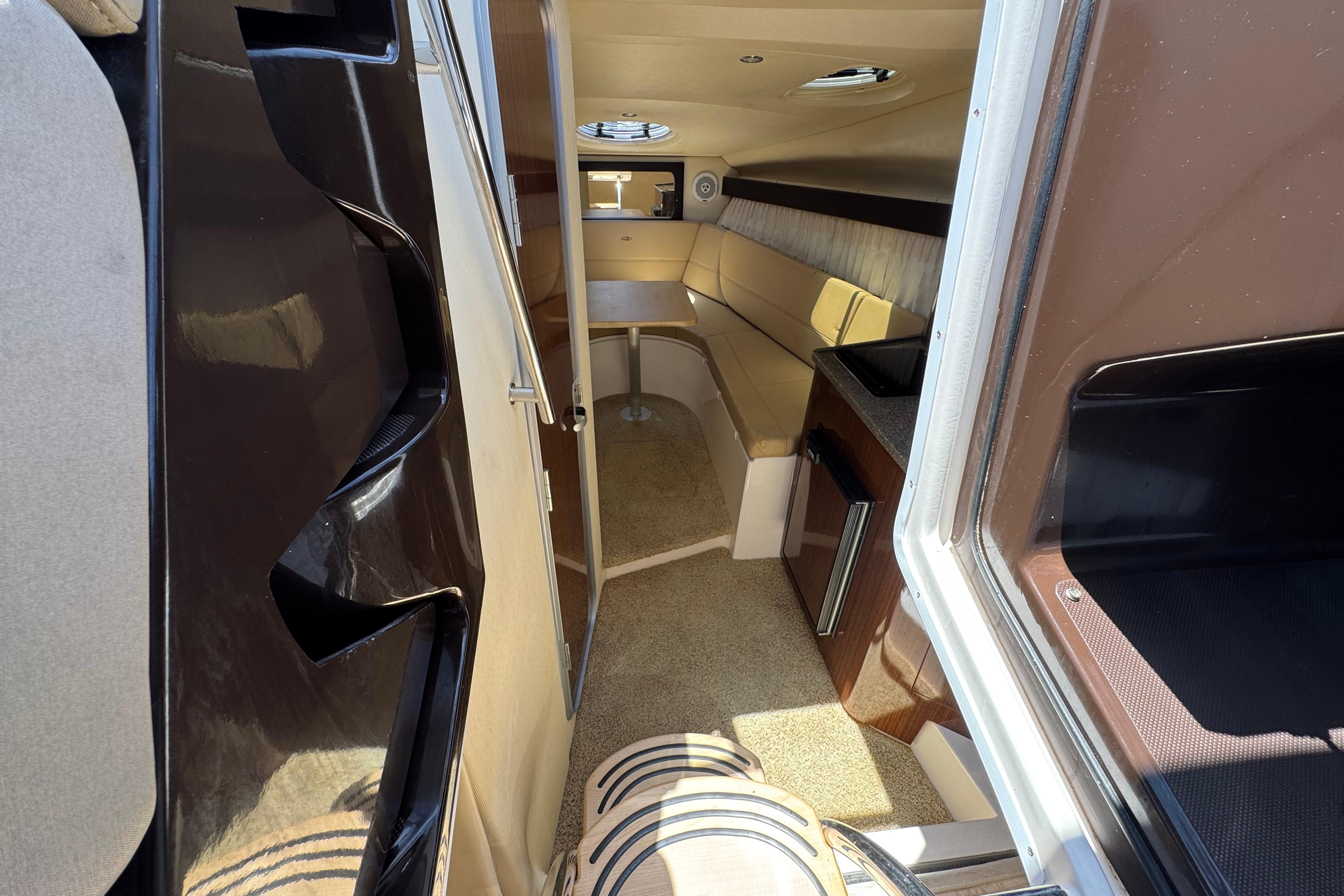 Interior view of a 2013 Regal 28 Express boat, featuring a cozy cabin and seating area.