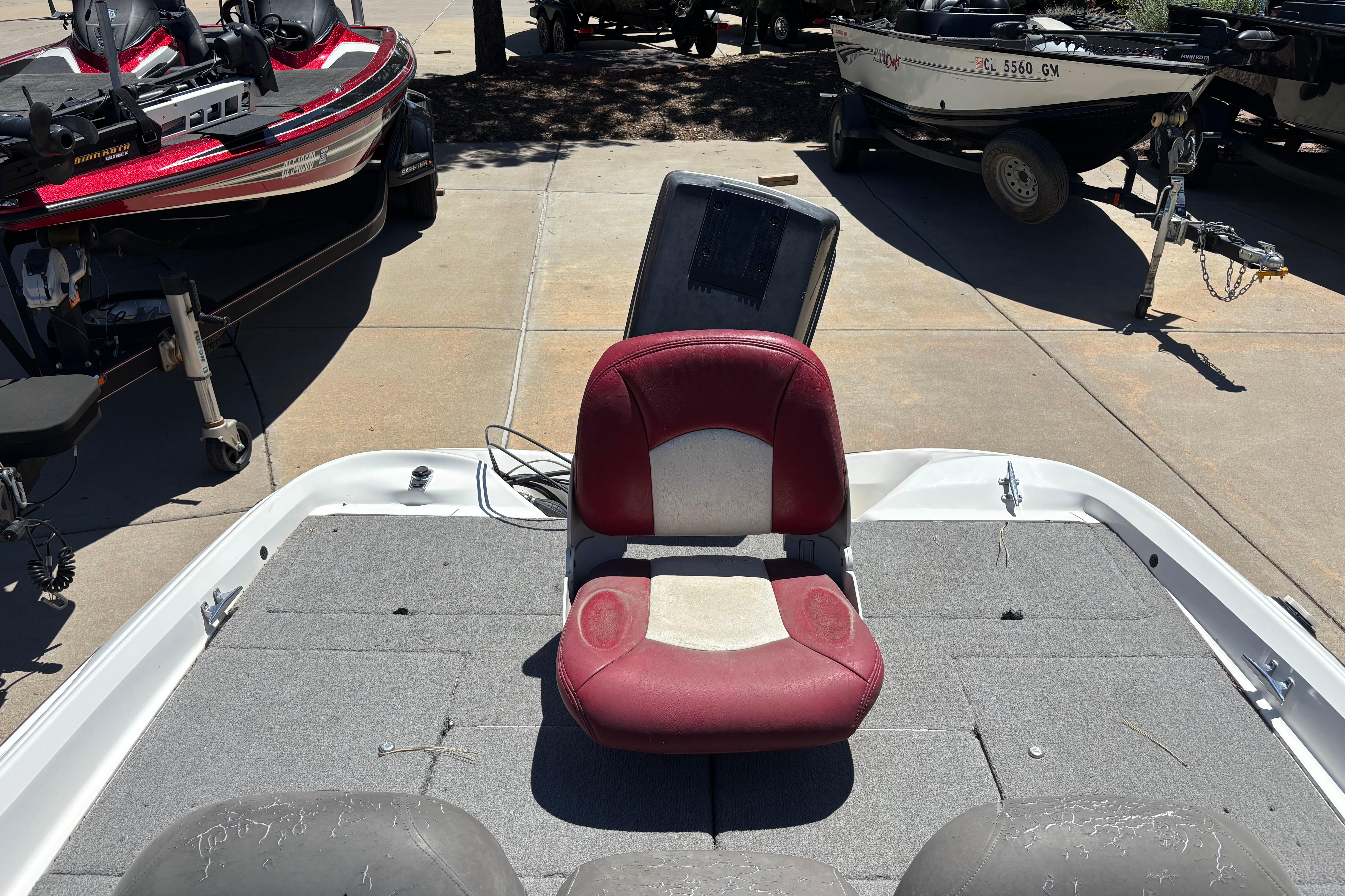 1998 Nitro 700 LX DC boat with red seat, parked among other boats.