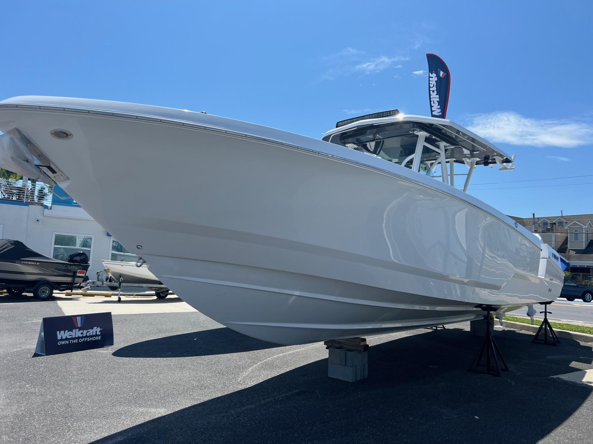 2025 Wellcraft 352 Fisherman boat displayed outdoors under clear blue sky.