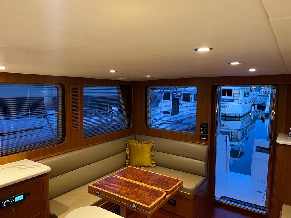 Luxurious interior of 2025 Bracewell 41 yacht with elegant seating and table.