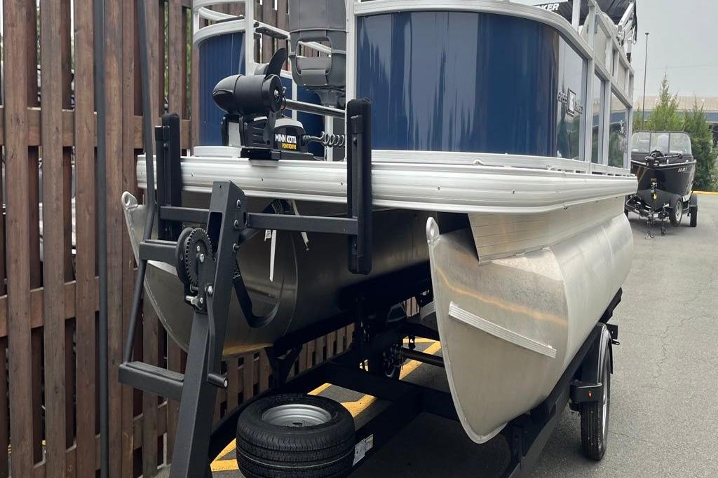 2026 Sun Tracker Bass Buggy 16 XL Select pontoon boat on trailer, featuring Minn Kota motor.