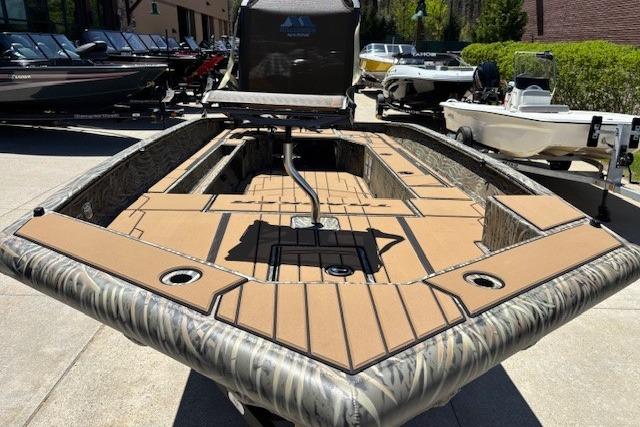 2026 Tracker Grizzly 1756 T Marsh boat with camo design, displayed outdoors.