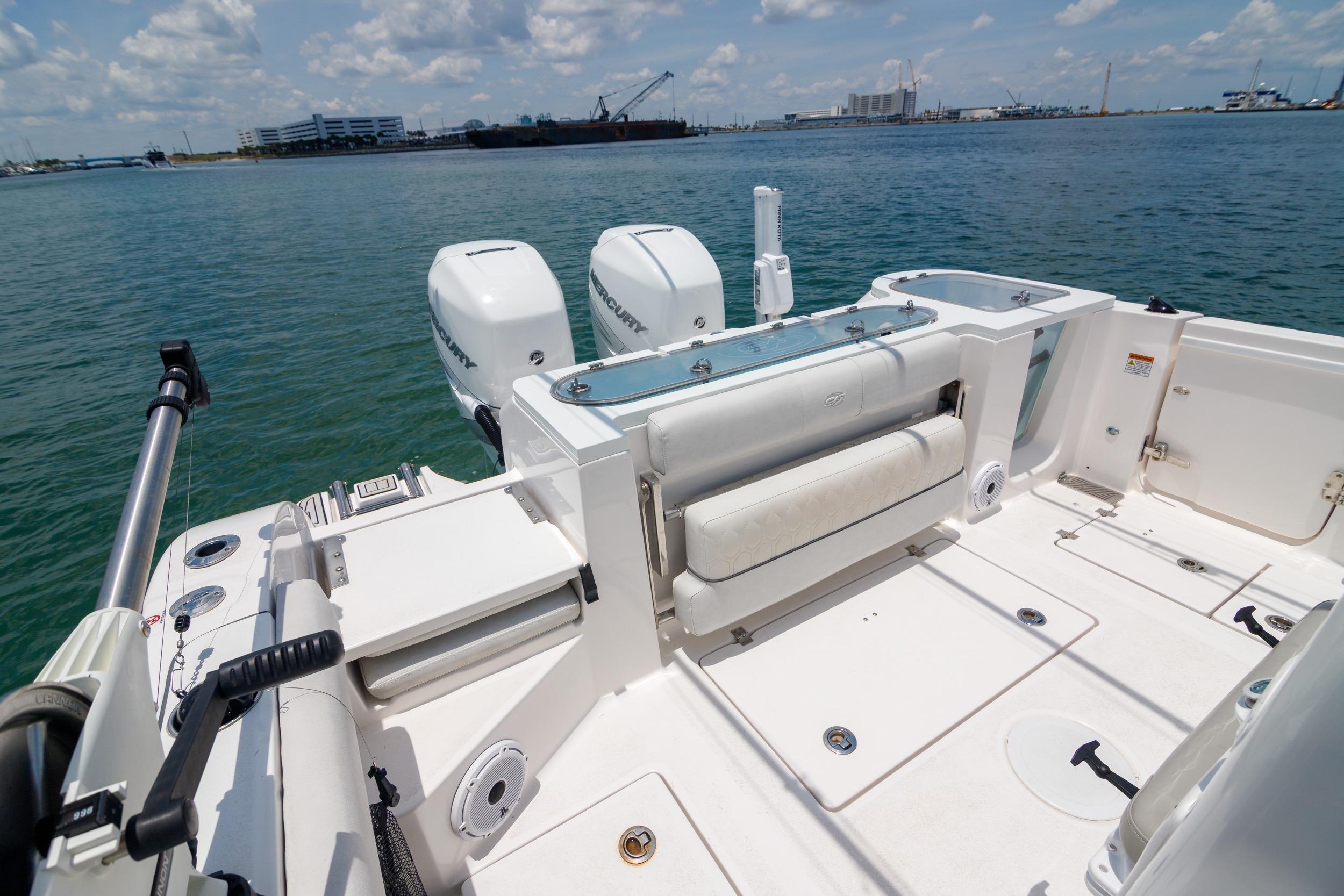 2021 Sea Fox 328 Commander boat deck with dual Mercury engines, docked on calm water.