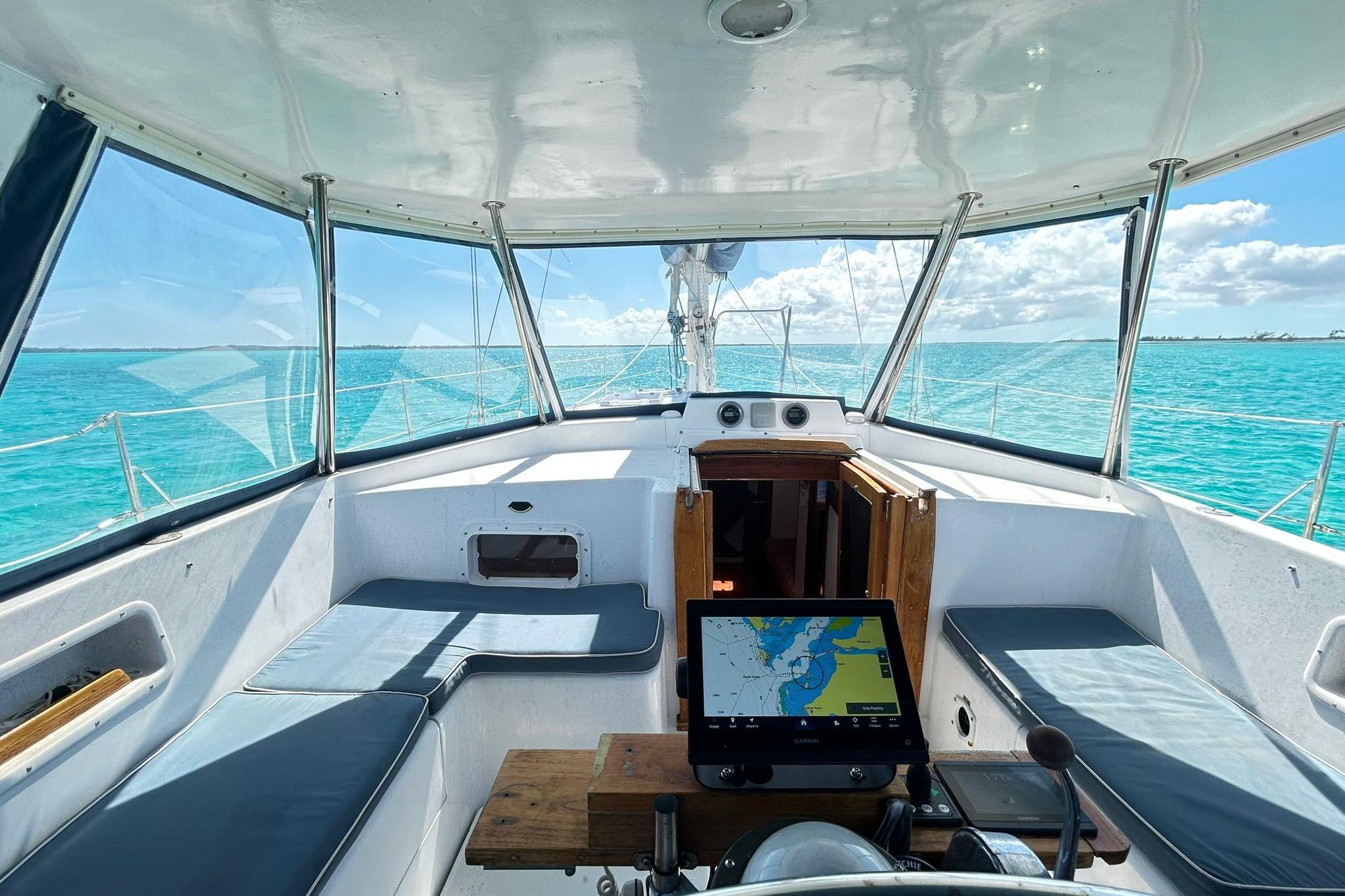 1987 Gulfstar CSY 50 Pilot House interior with navigation system, overlooking turquoise ocean waters.