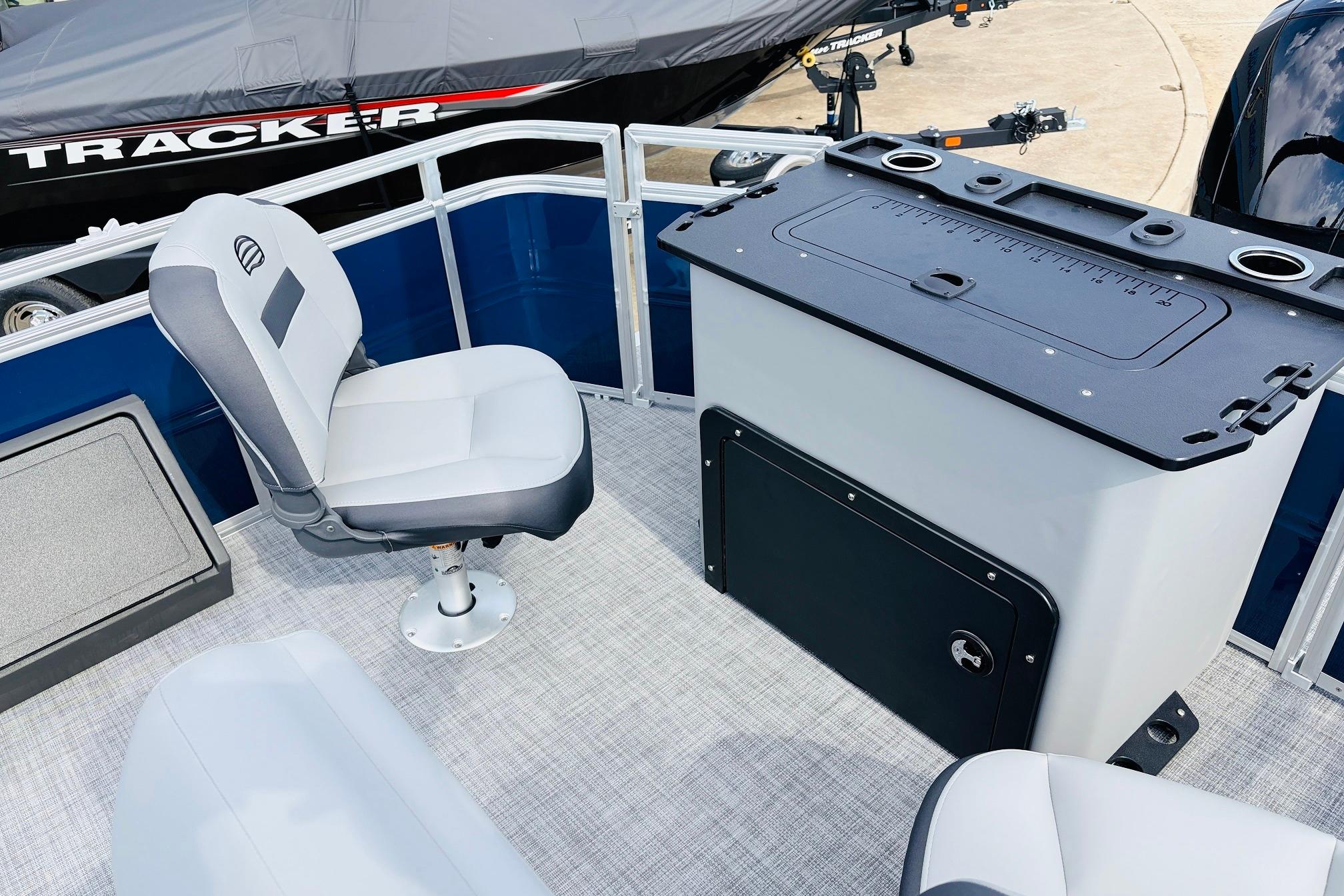 Interior of 2026 Sun Tracker SportFish 22 DLX pontoon boat with seating and storage.