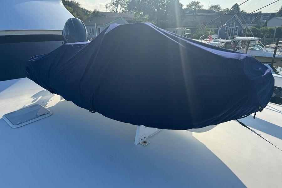 Covered equipment on 2002 Viking 61 Enclosed Bridge yacht deck, sunny day.
