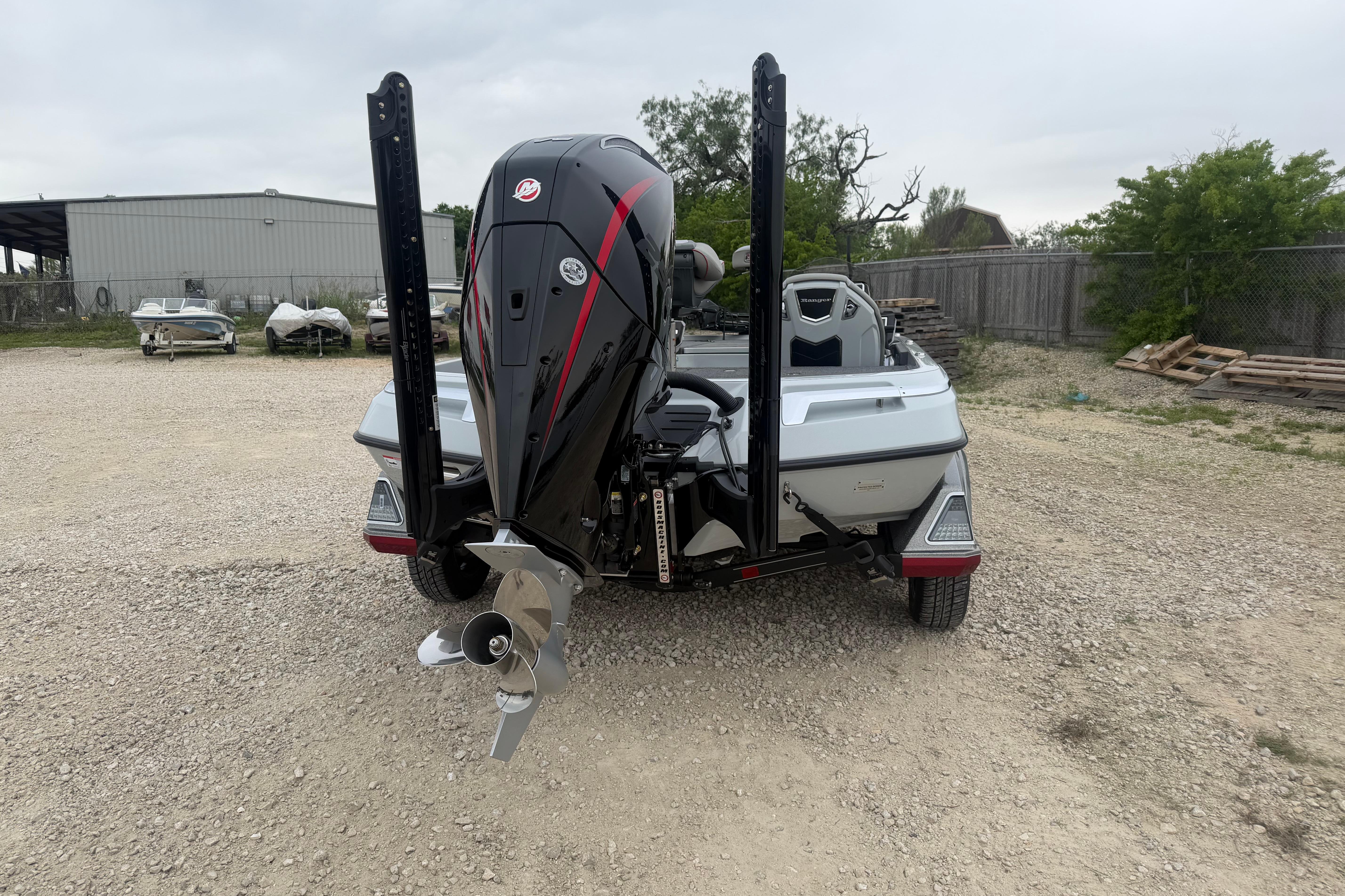 2026 Ranger Z521R Cup-Equipped boat, rear view, parked on gravel lot.