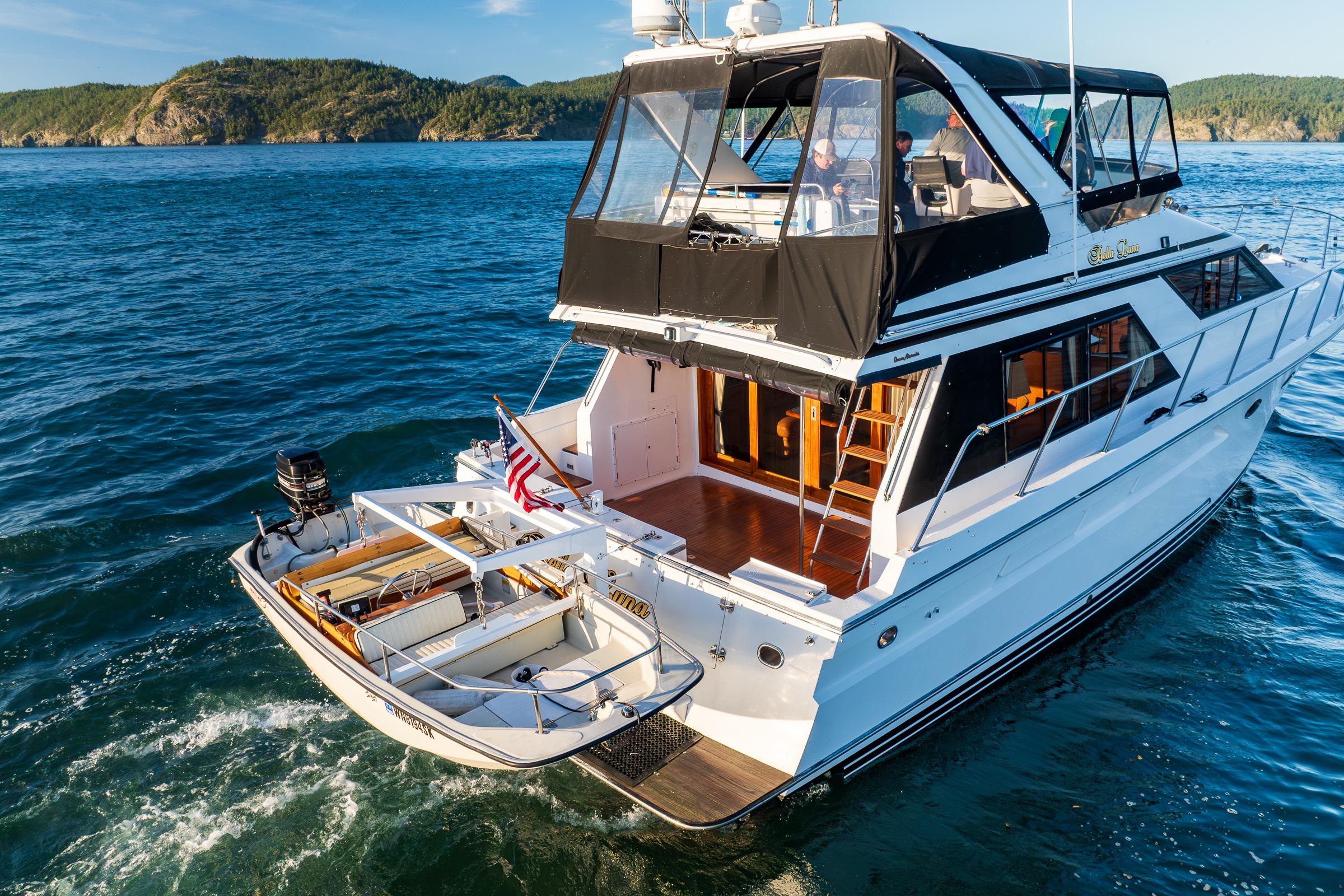 1990 Ocean Alexander 48 Sedan yacht cruising on scenic blue waters.