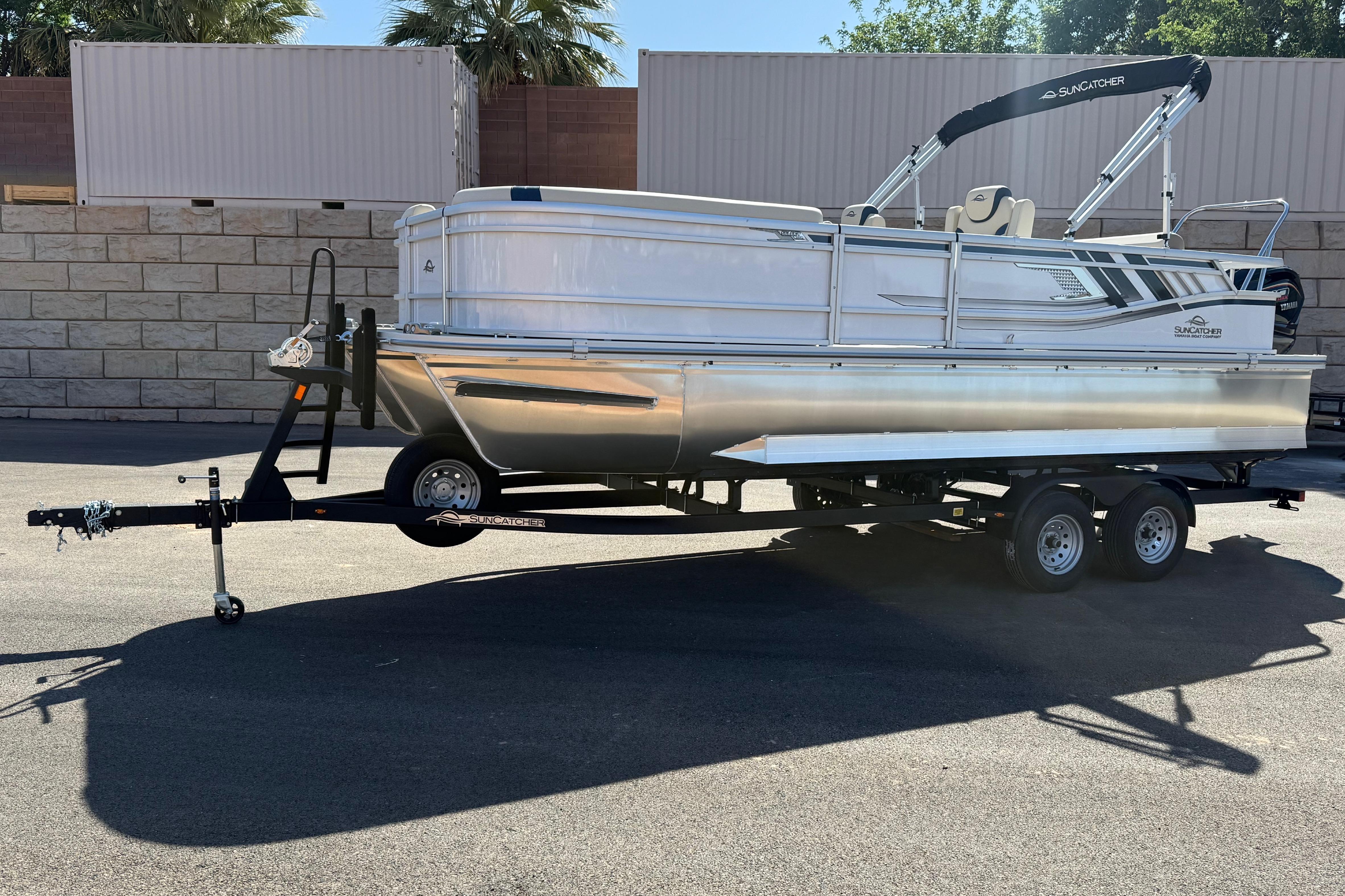 2026 SunCatcher Select 322SL pontoon boat on trailer, parked outdoors.