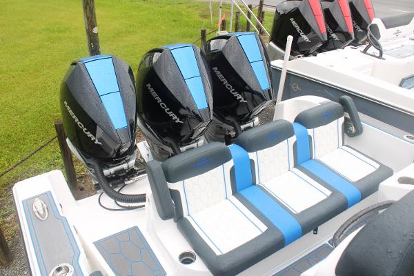2024 Fountain 34 SC boat with Mercury outboard engines and blue-accented seating.