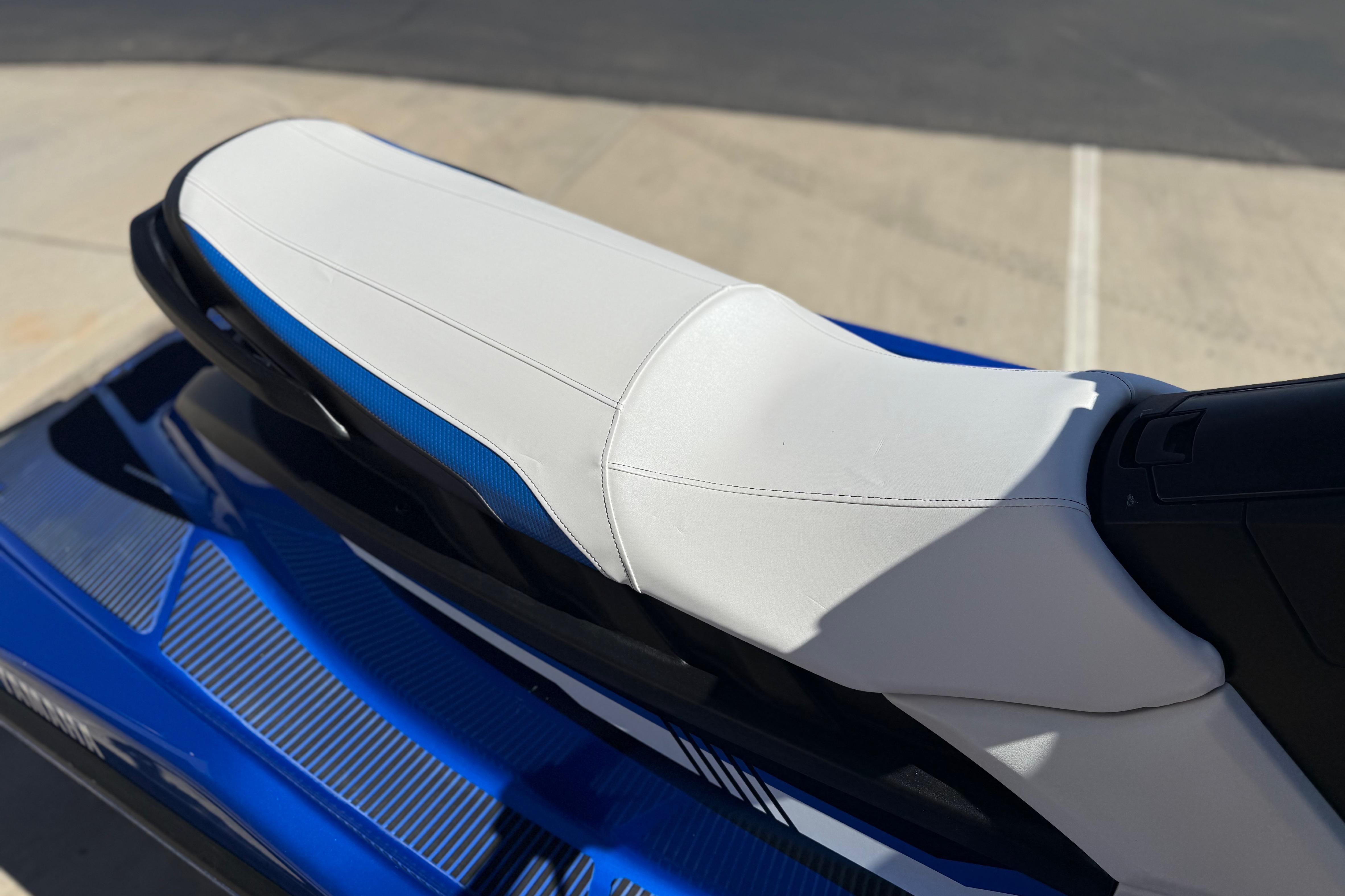 2017 Yamaha WaveRunner EX Deluxe with white and blue seat, parked on pavement.