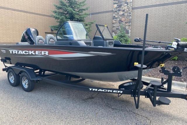2025 Tracker Targa V-19 Combo boat on trailer, parked outdoors.