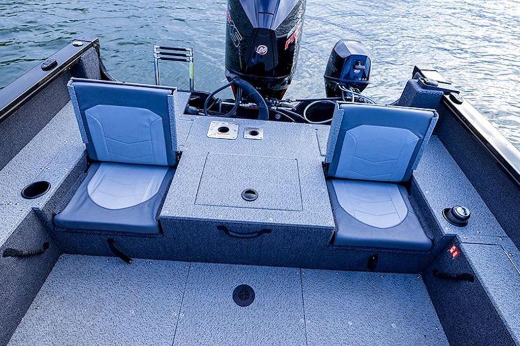 2026 Lowe Fishing Machine 1875 boat interior with dual seats and motor on water.