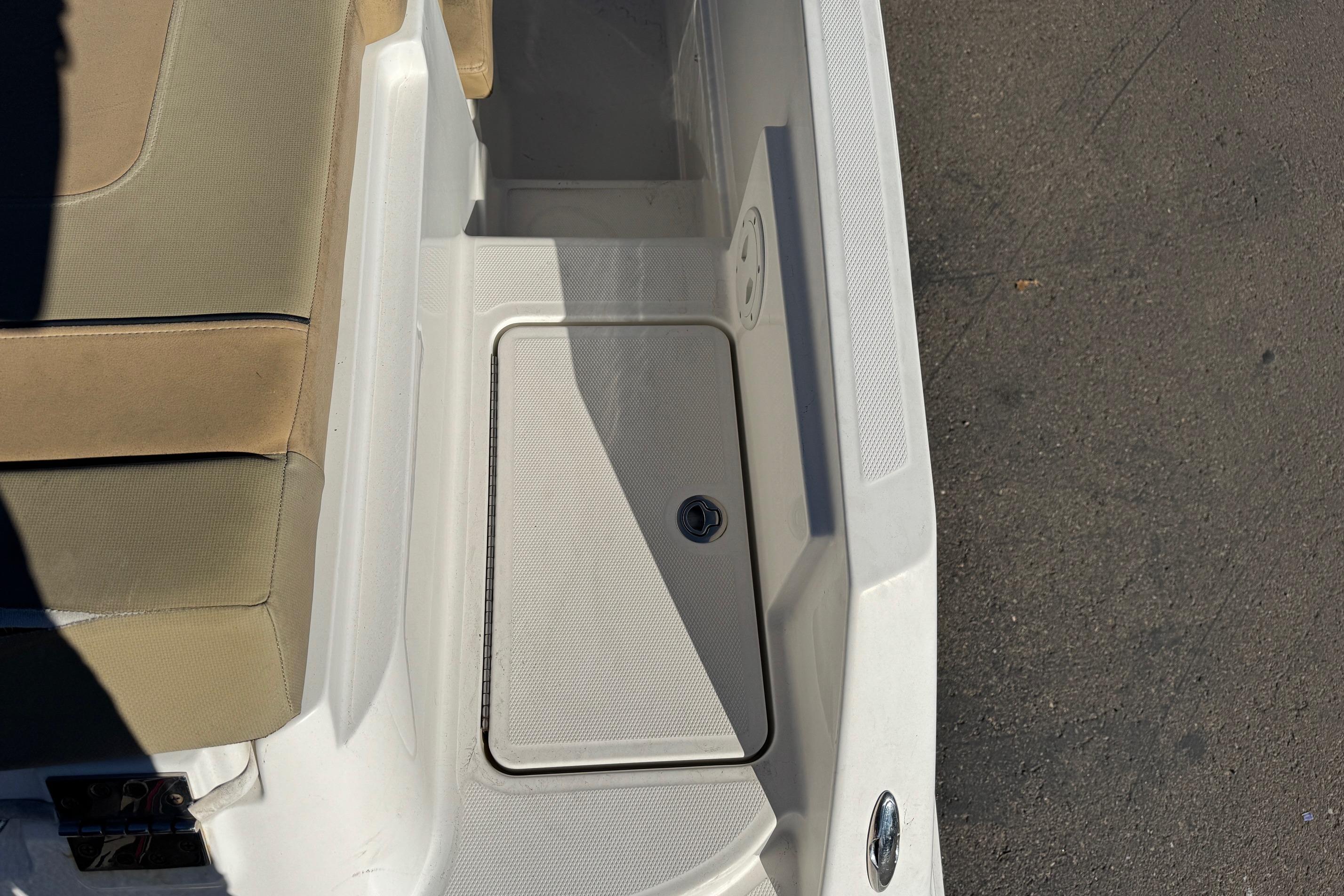 2022 Bayliner VR6 Bowrider OB interior with beige seating and storage compartment.