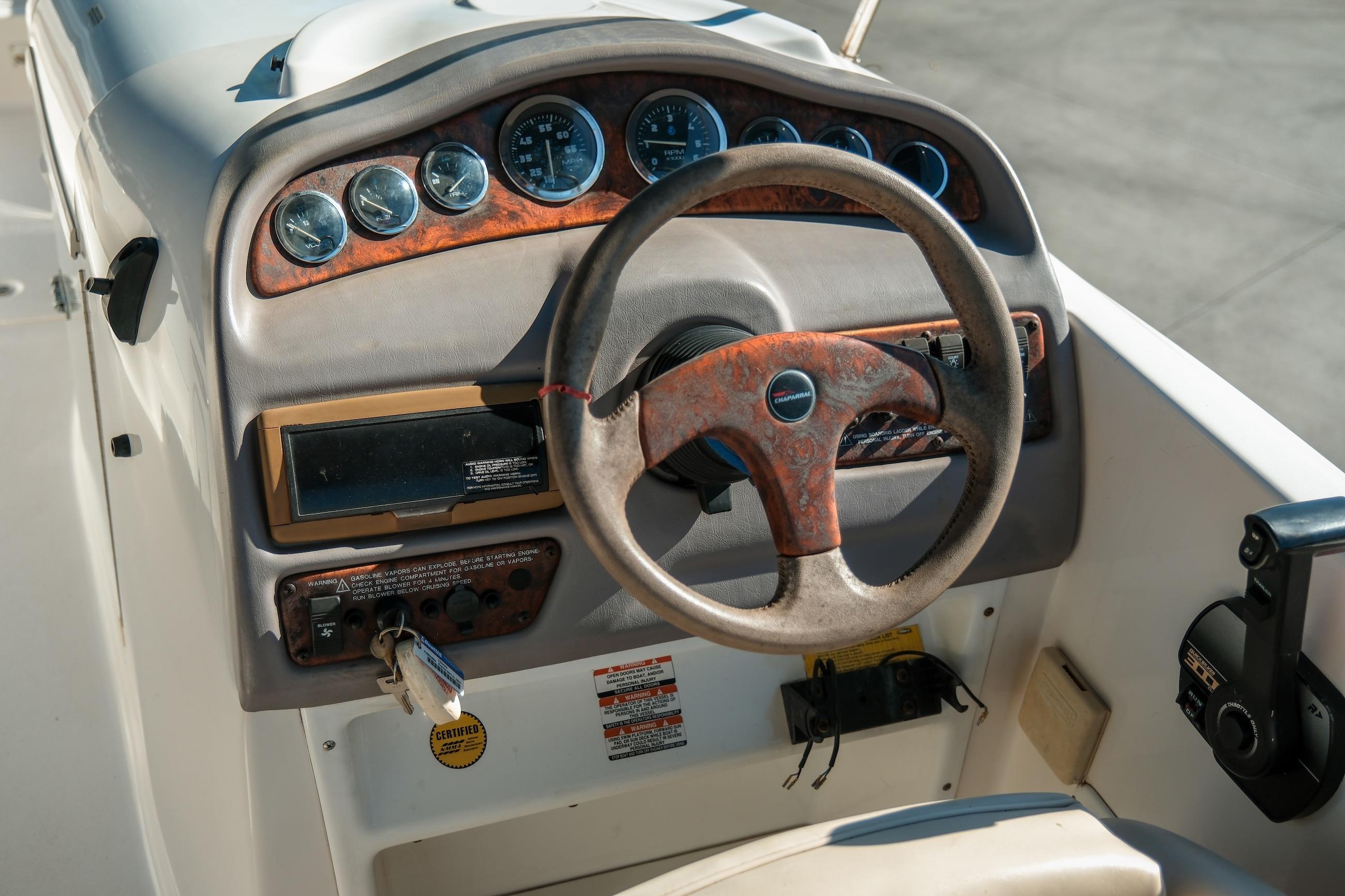 1998 Chaparral 232 Sunesta boat dashboard with steering wheel and instrument panel.