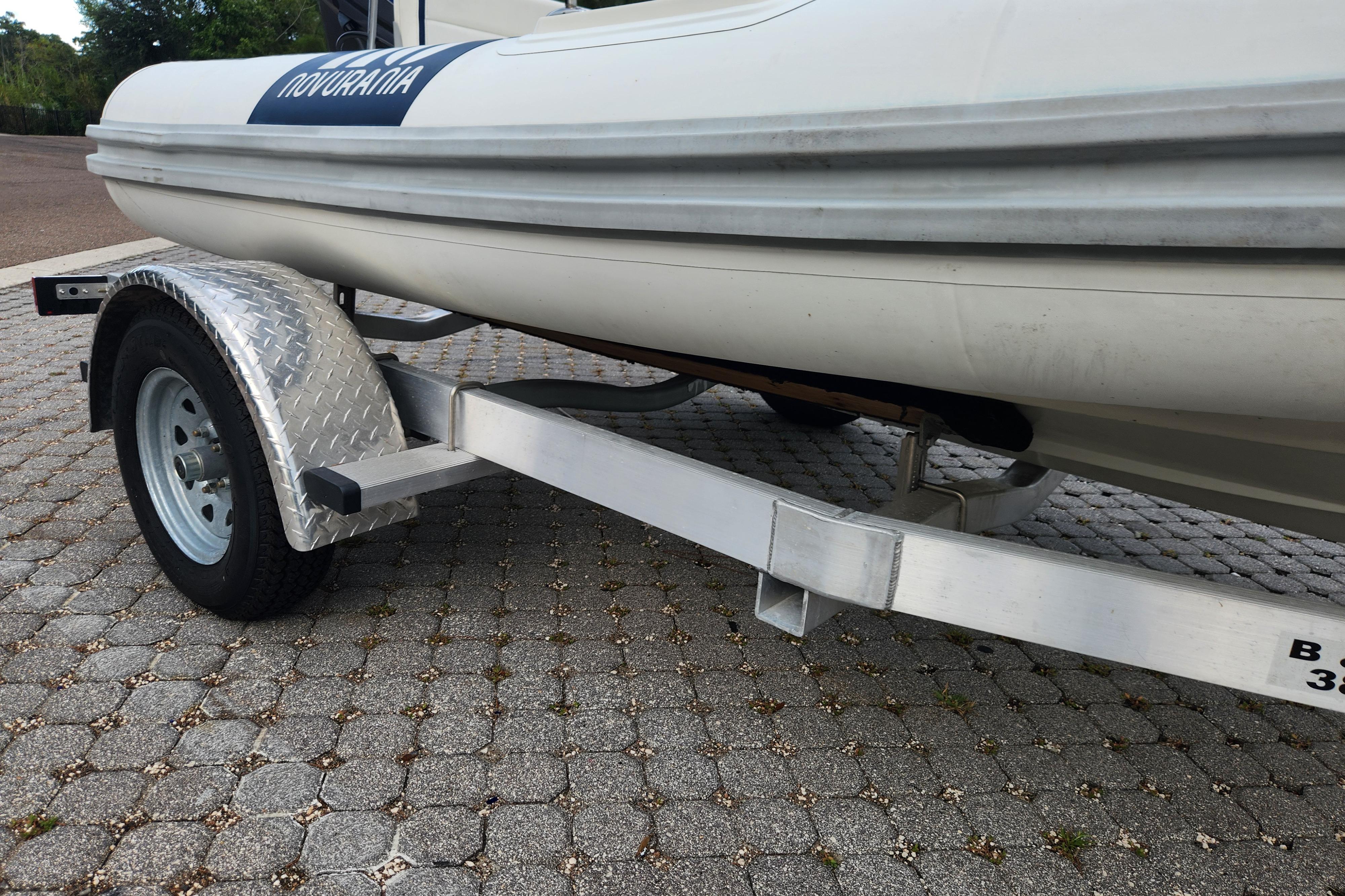 2019 Novurania DL 400 boat on a trailer, parked on a paved surface.