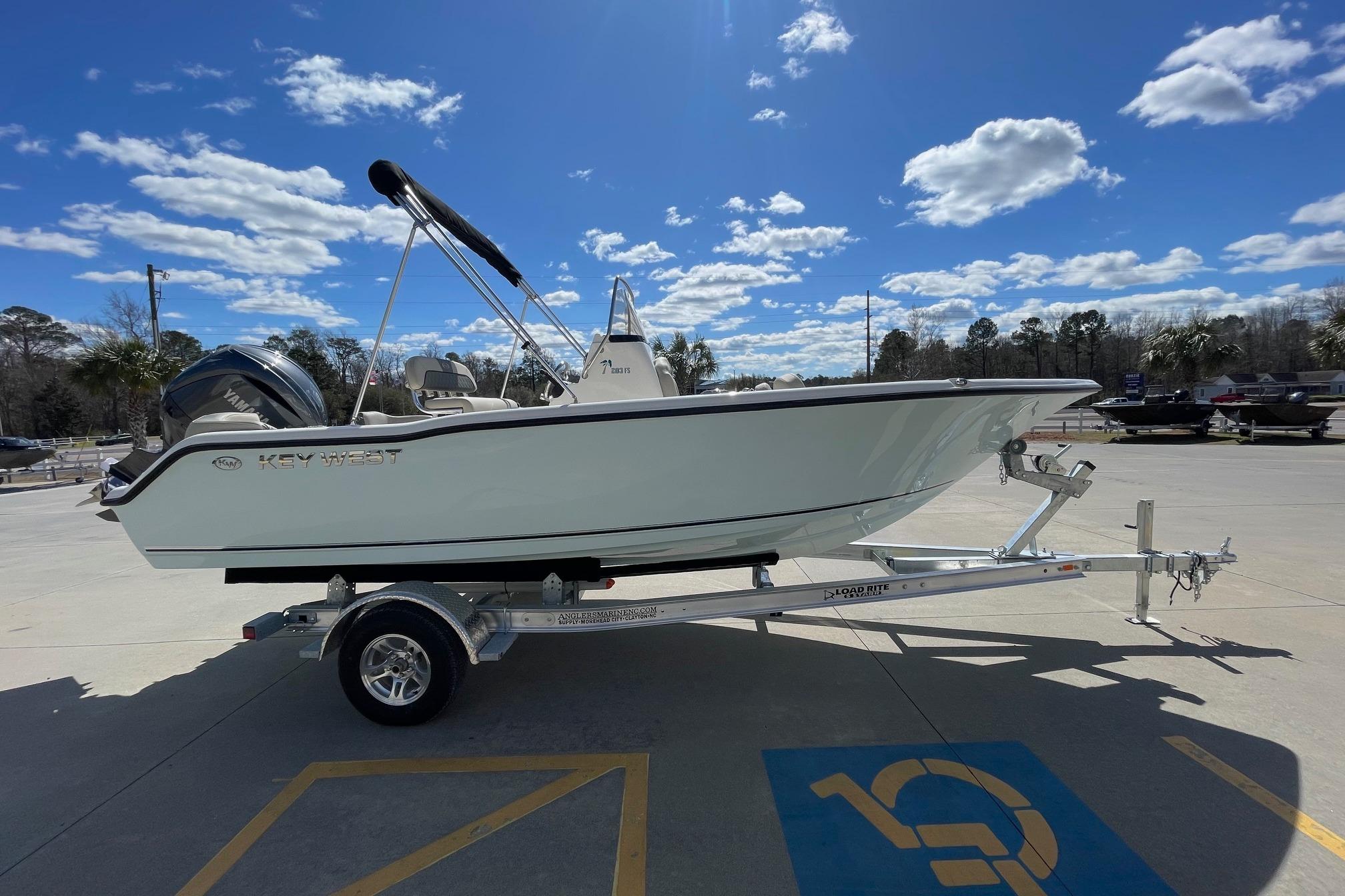 2026 Key West 203 FS boat on trailer under a clear blue sky.