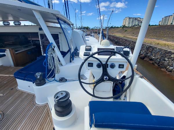 Catana 65 yacht 2009 model, featuring a spacious deck and modern steering wheel.