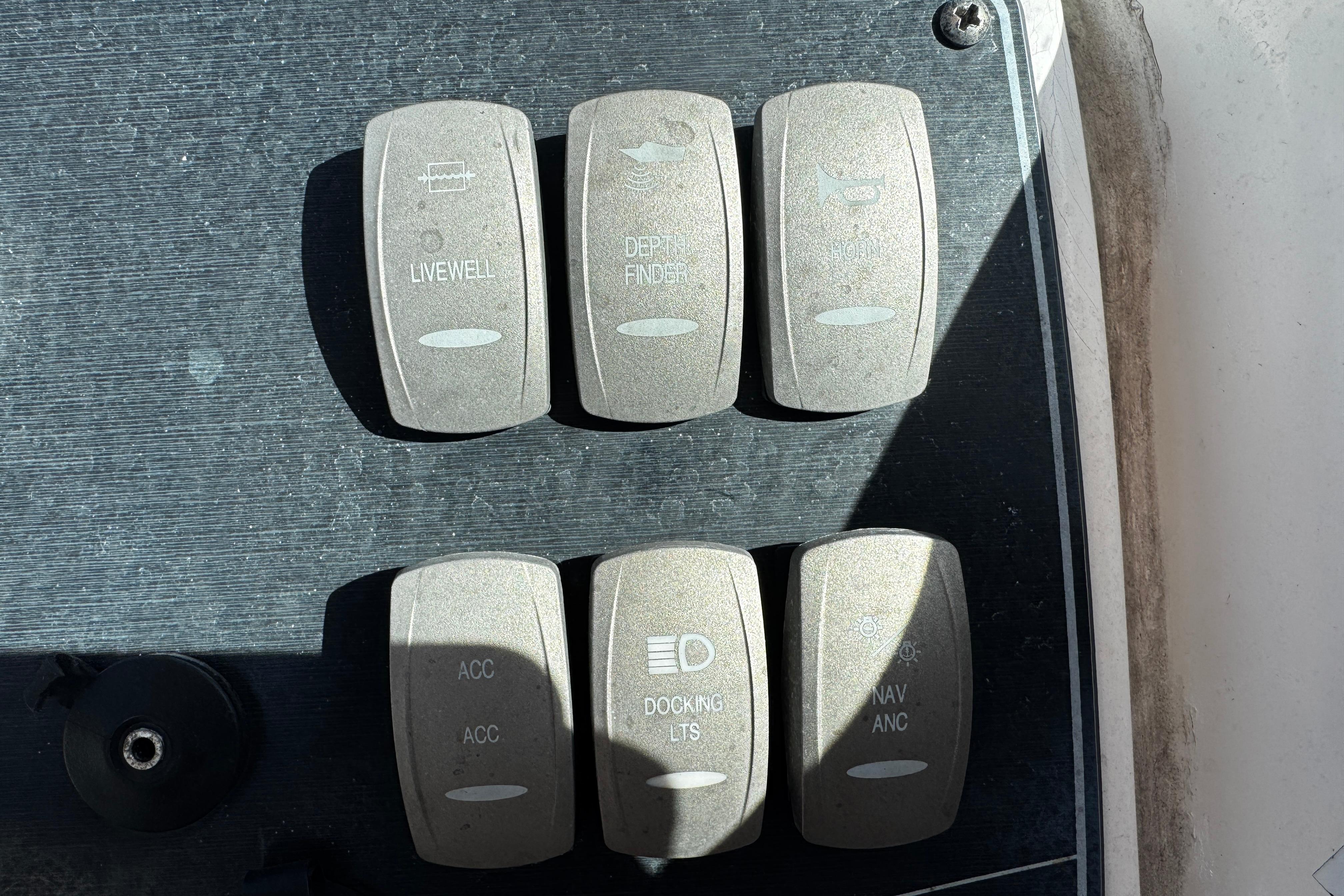 Control panel of a 2021 Hurricane SunDeck 2200 DC OB boat with labeled switches.