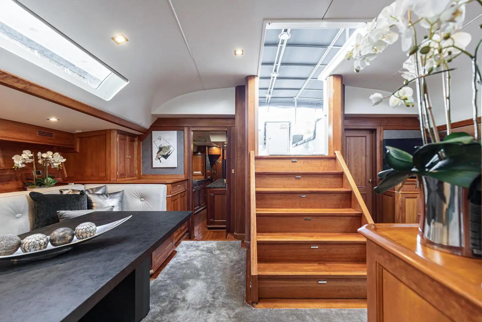 Luxurious yacht interior with wooden stairs, elegant seating, and decorative elements, JMV Industries Vaton 100.
