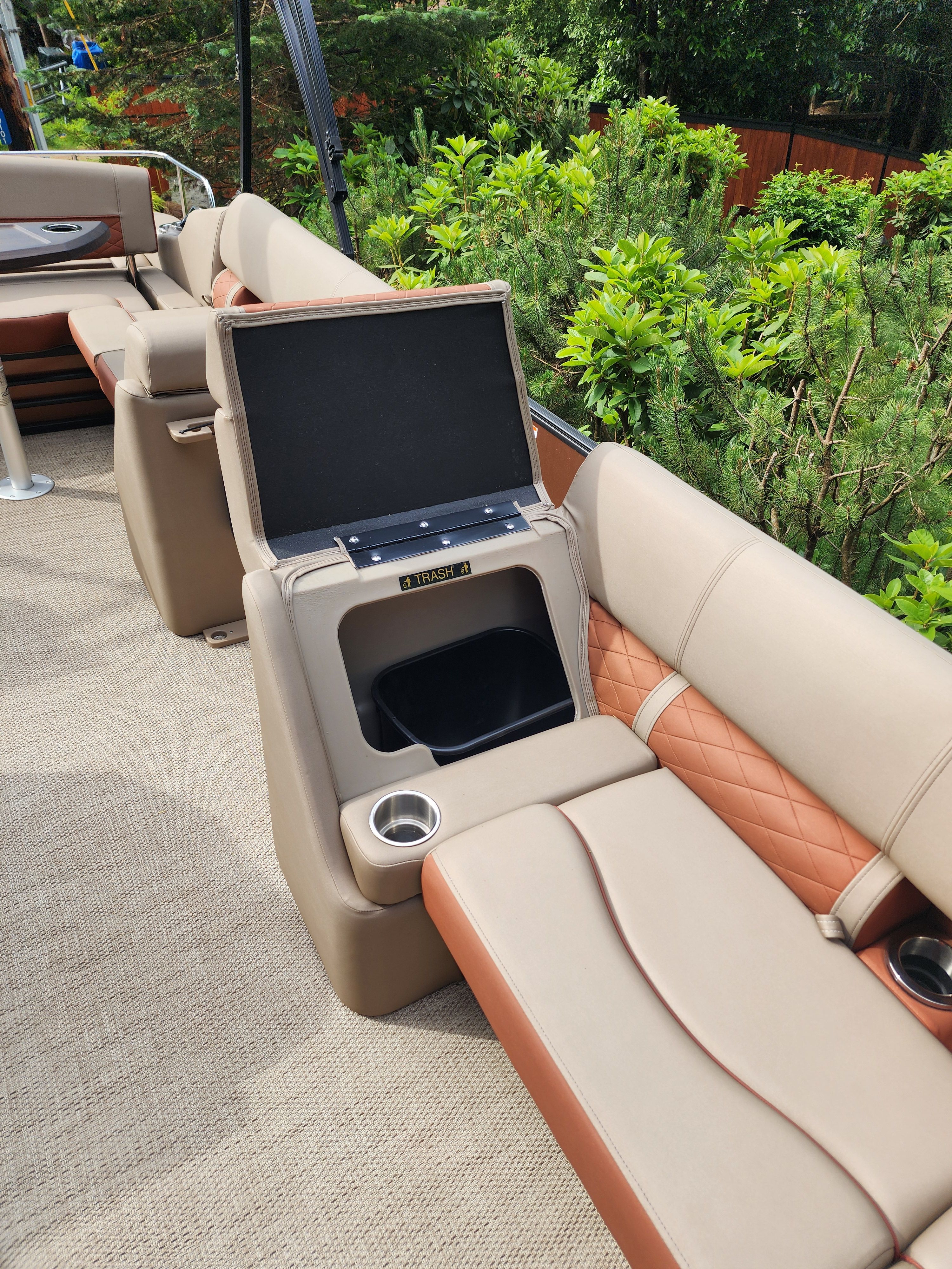 The image shows the interior of a Bennington 22 LSB boat with beige and brown seating.