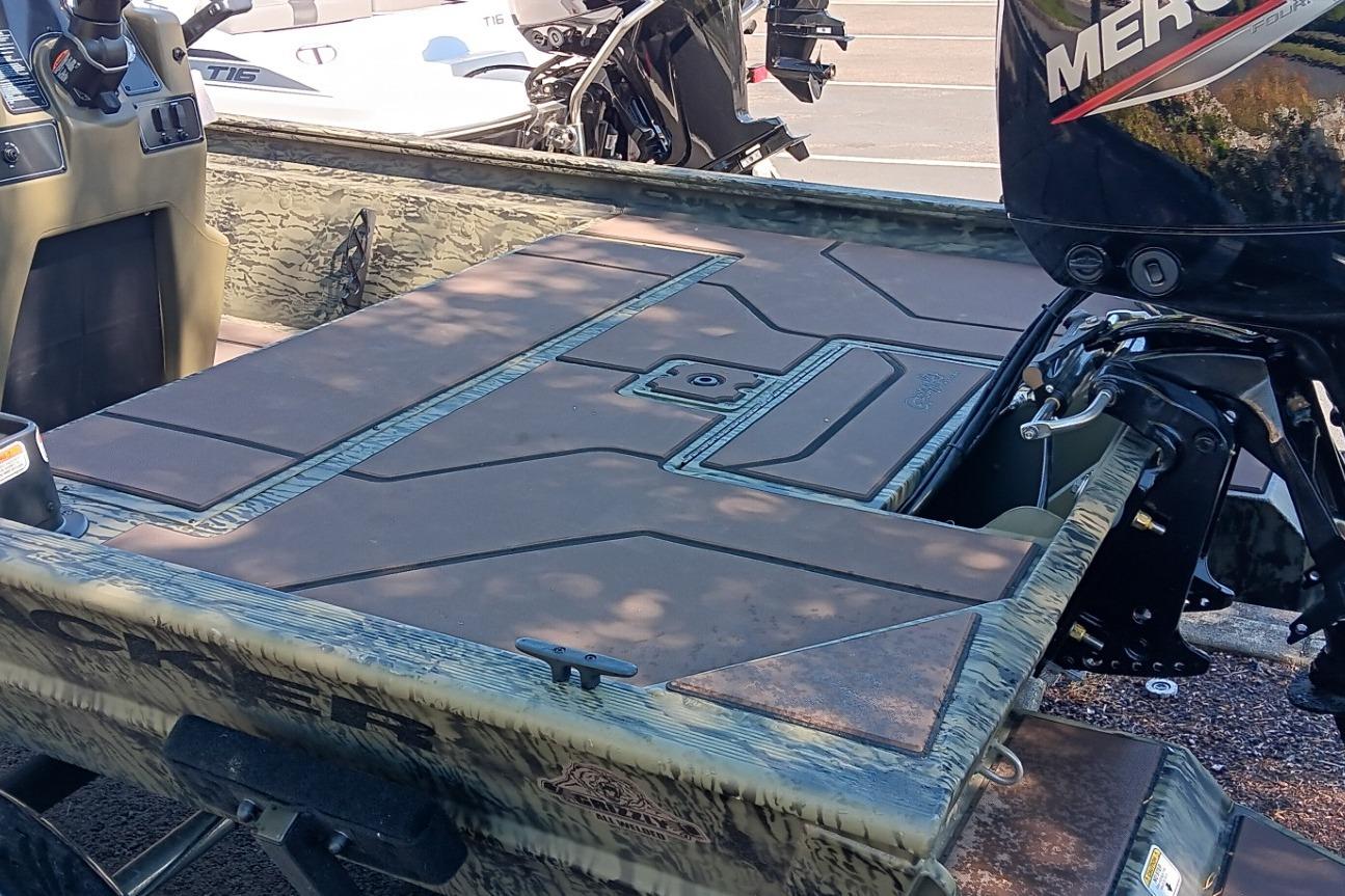 2026 Tracker Grizzly 1860 CC boat with Mercury outboard motor, featuring spacious deck design.