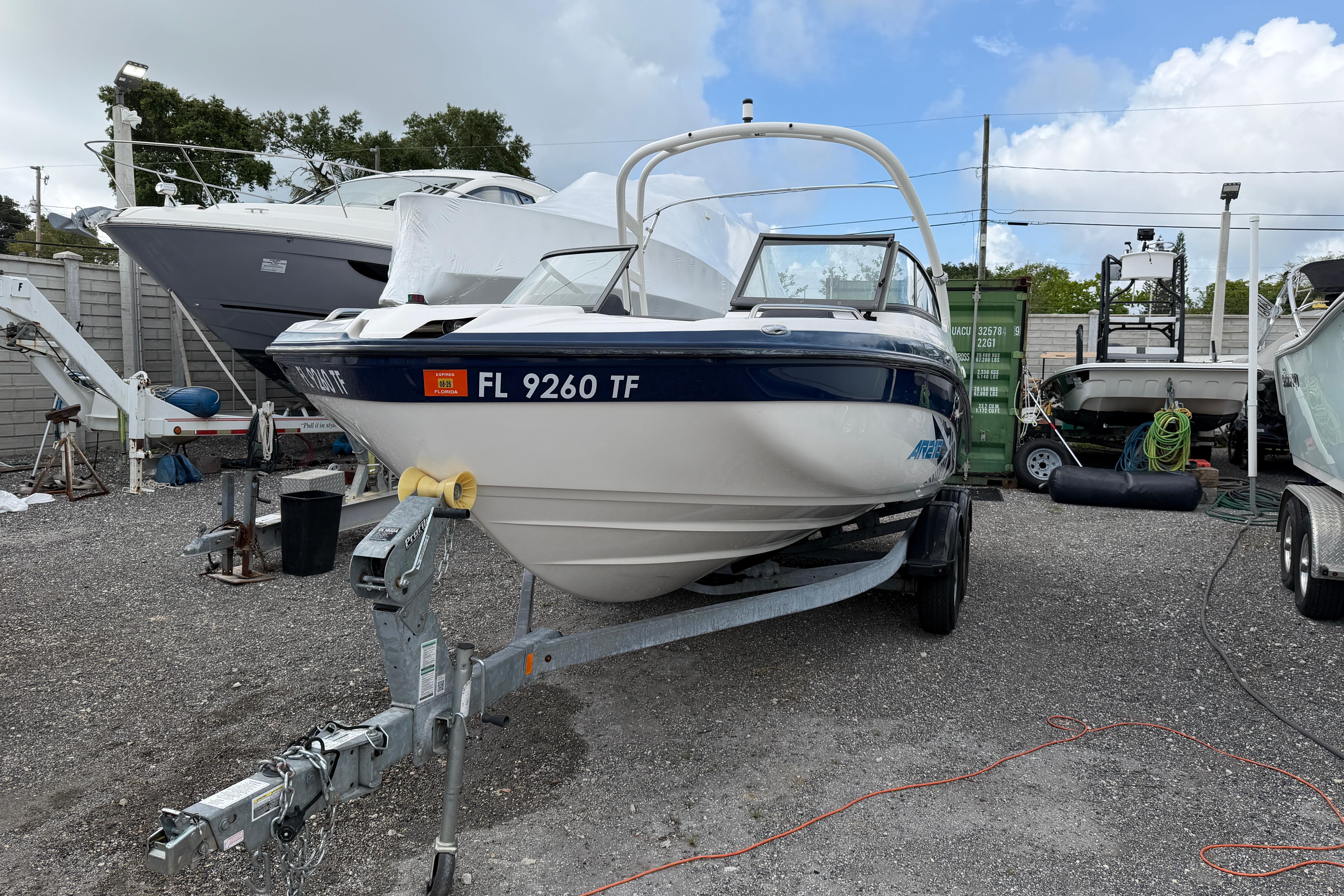 2022 Yamaha AR210 boat on trailer in a marina setting.