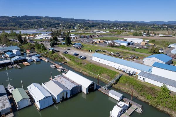 Aerial view of Larson Boathouse, 1985, with surrounding landscape and waterway.