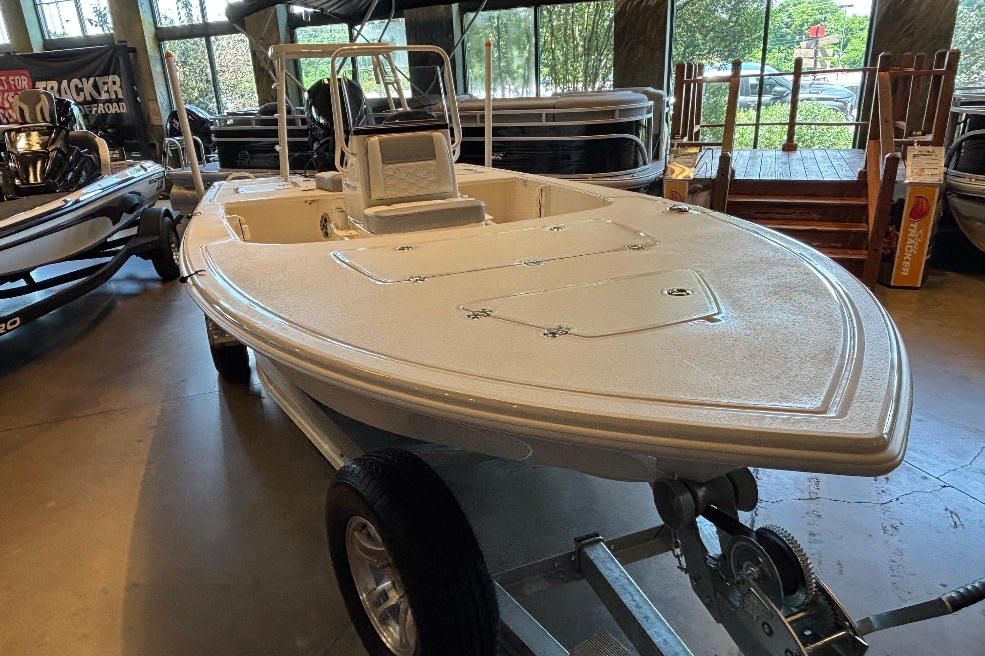 2026 Mako 18 Pro Skiff boat displayed indoors on a trailer.